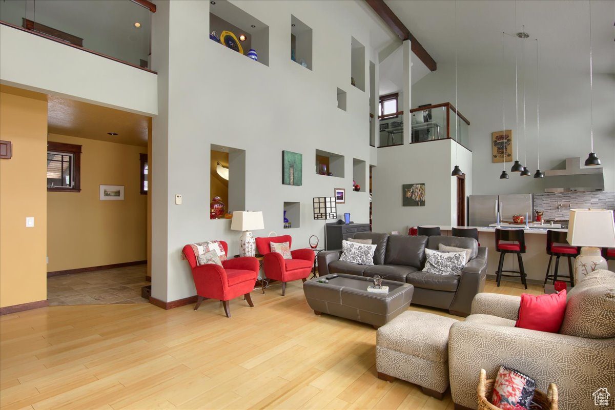Living area with light wood finished floors and baseboards