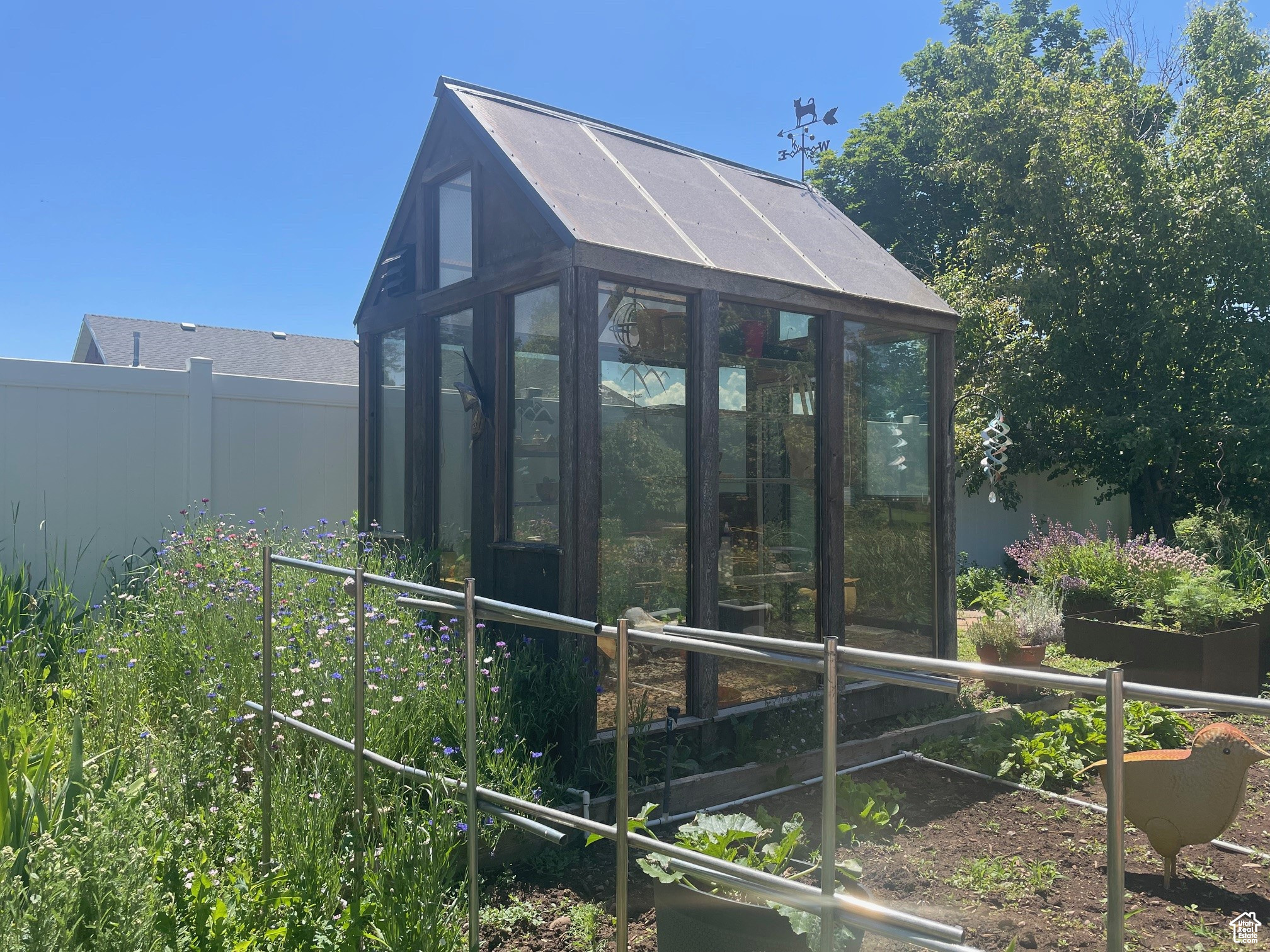 View of greenhouse featuring fence
