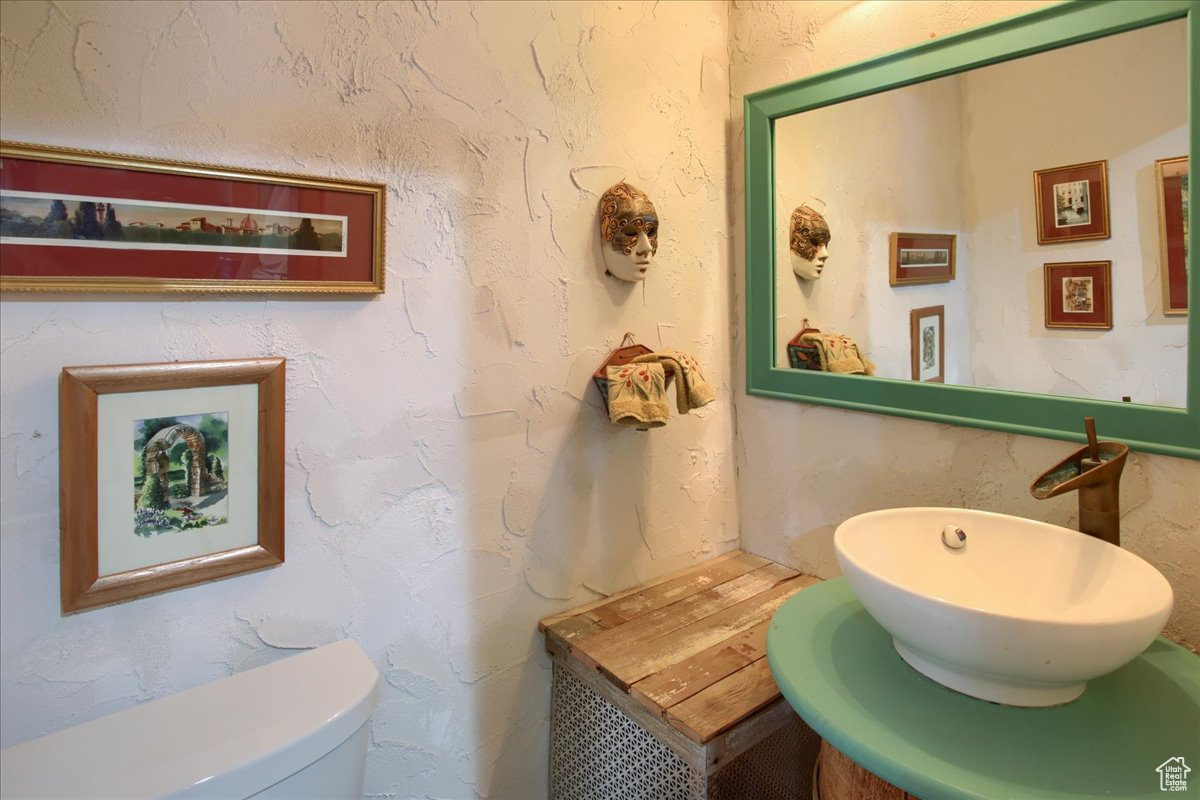 Half bathroom with a sink and toilet