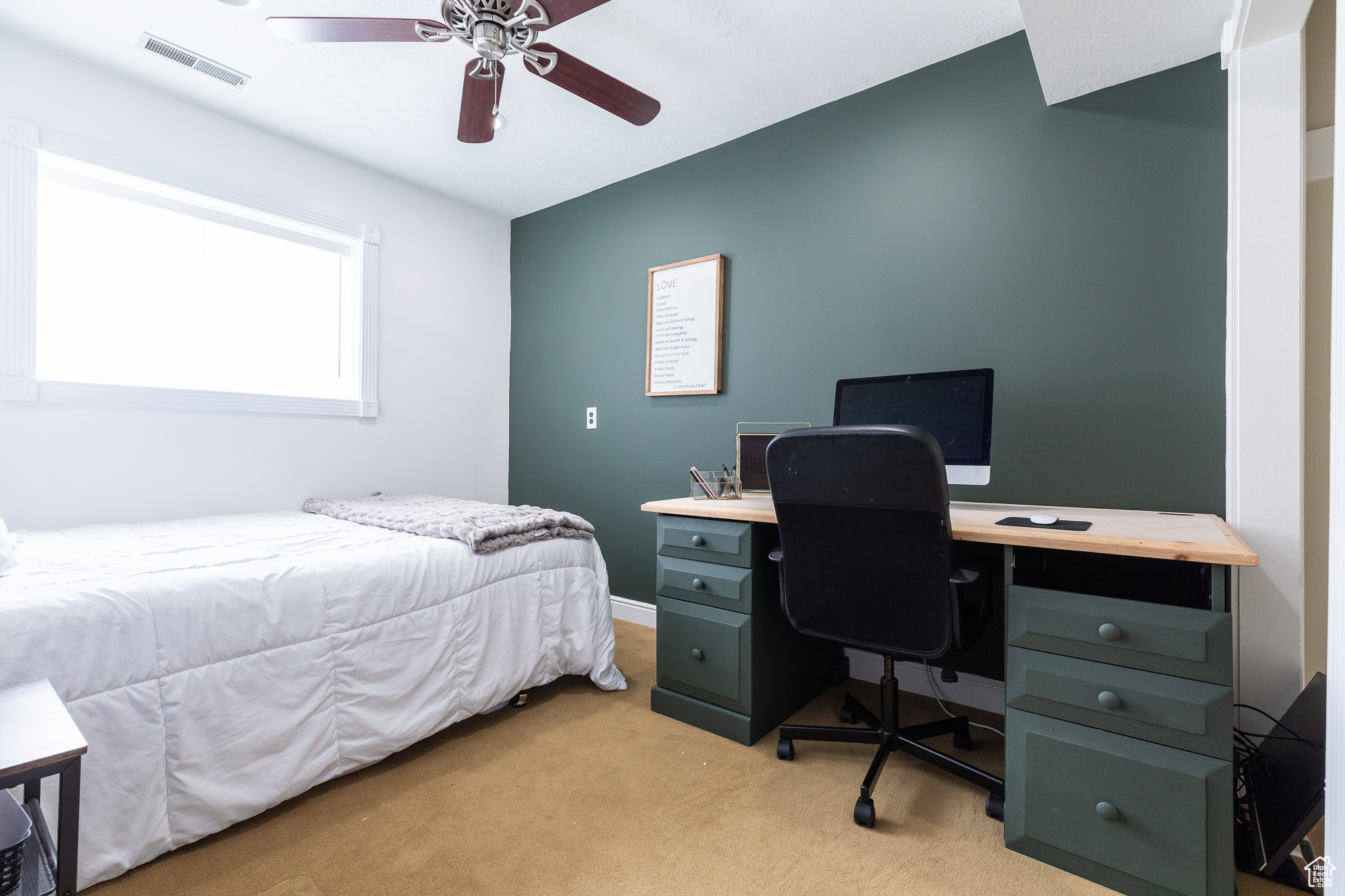 Bedroom with a ceiling fan, visible vents, and light carpet