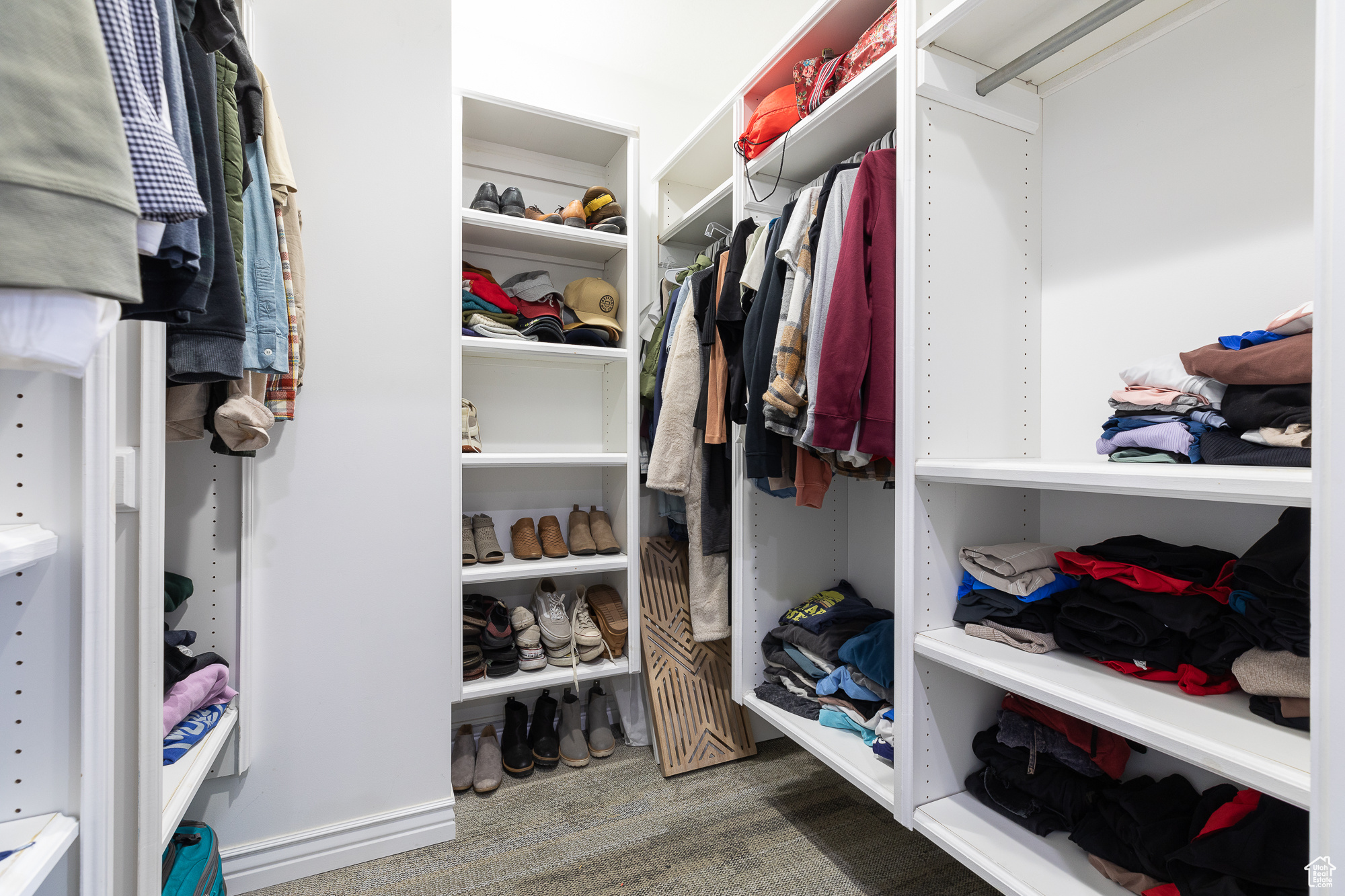 Spacious closet with dark wood-style floors
