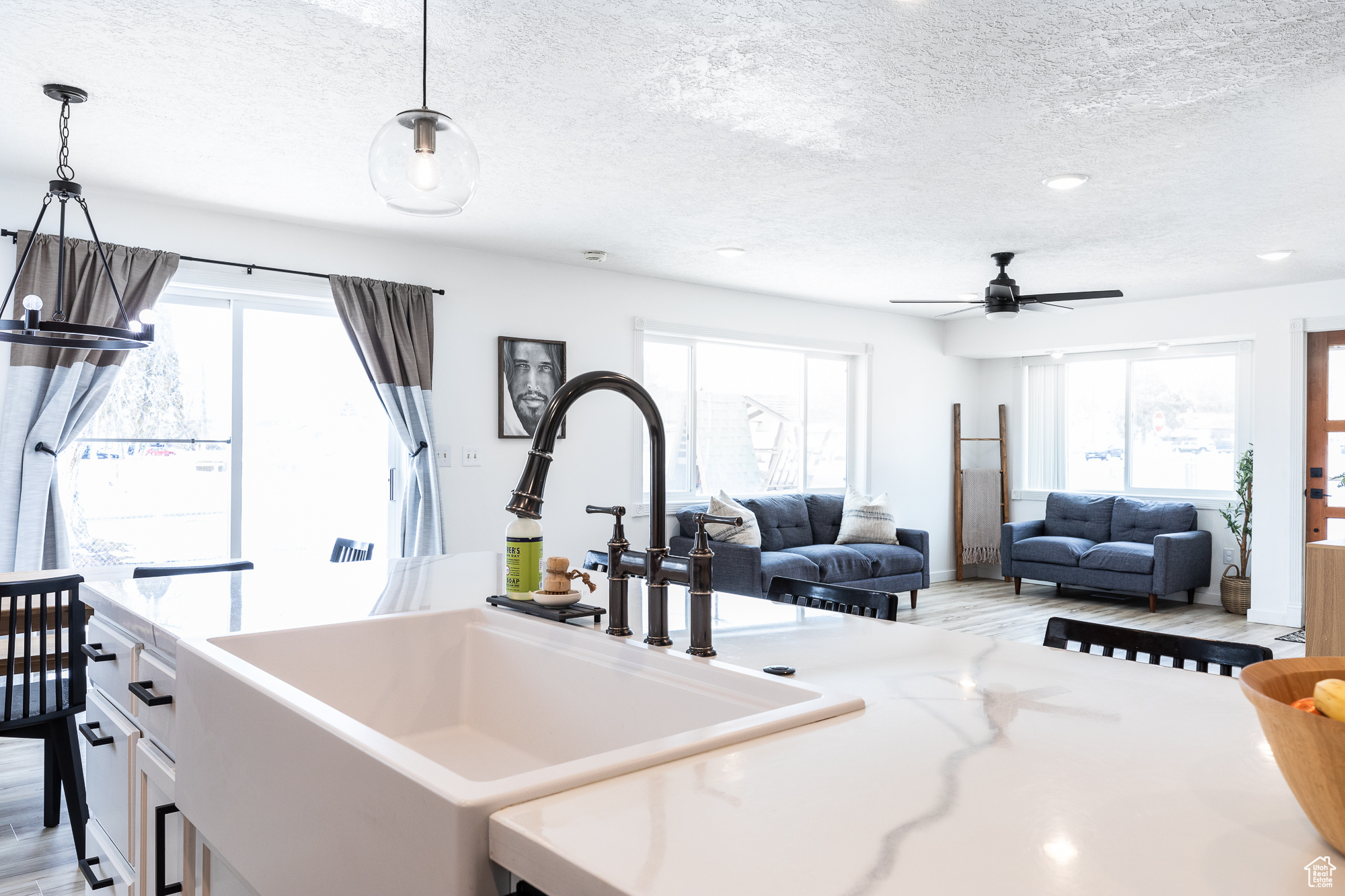 Kitchen with open floor plan, plenty of natural light, a sink, and pendant lighting
