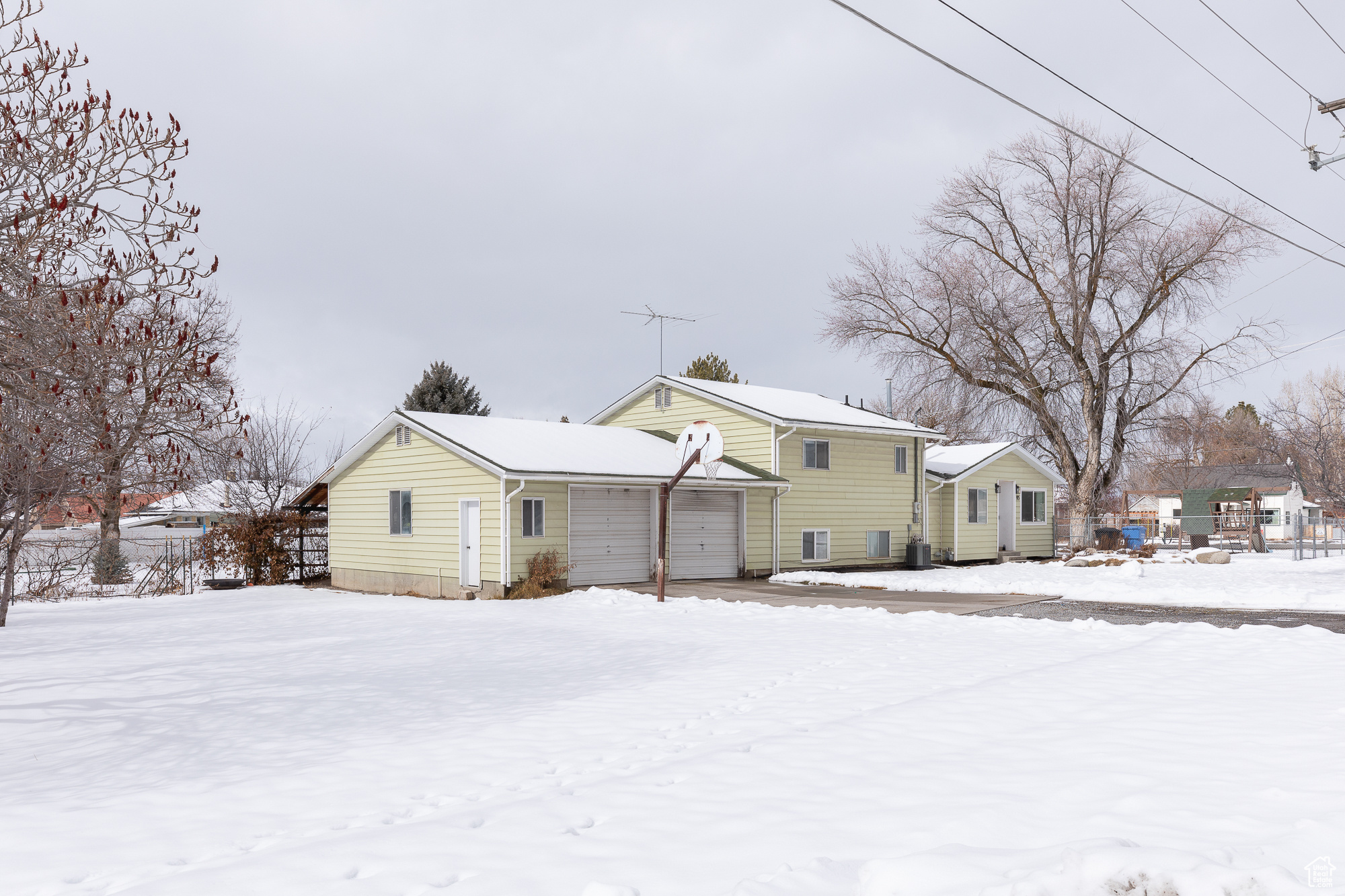 Snow covered house with a garage