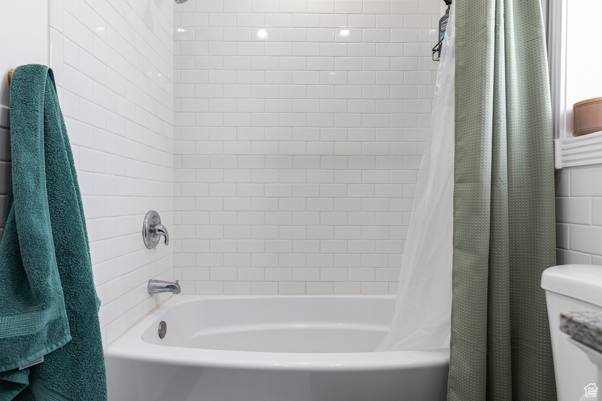 Bathroom with toilet and shower / bathtub combination with curtain