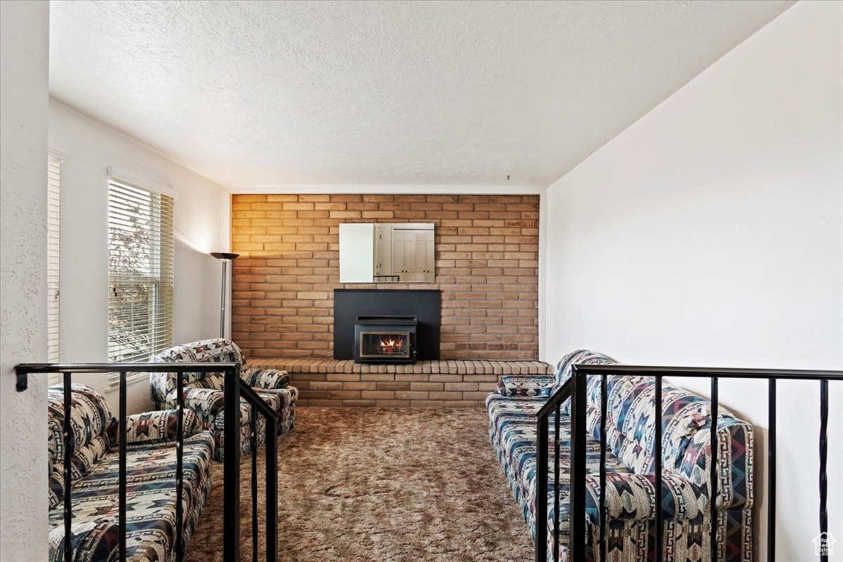 Carpeted living area with a textured ceiling