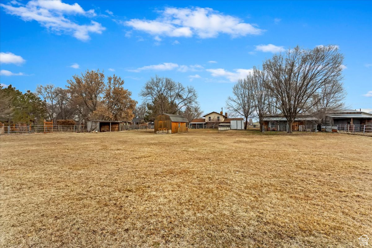 View of yard with an outbuilding and fence