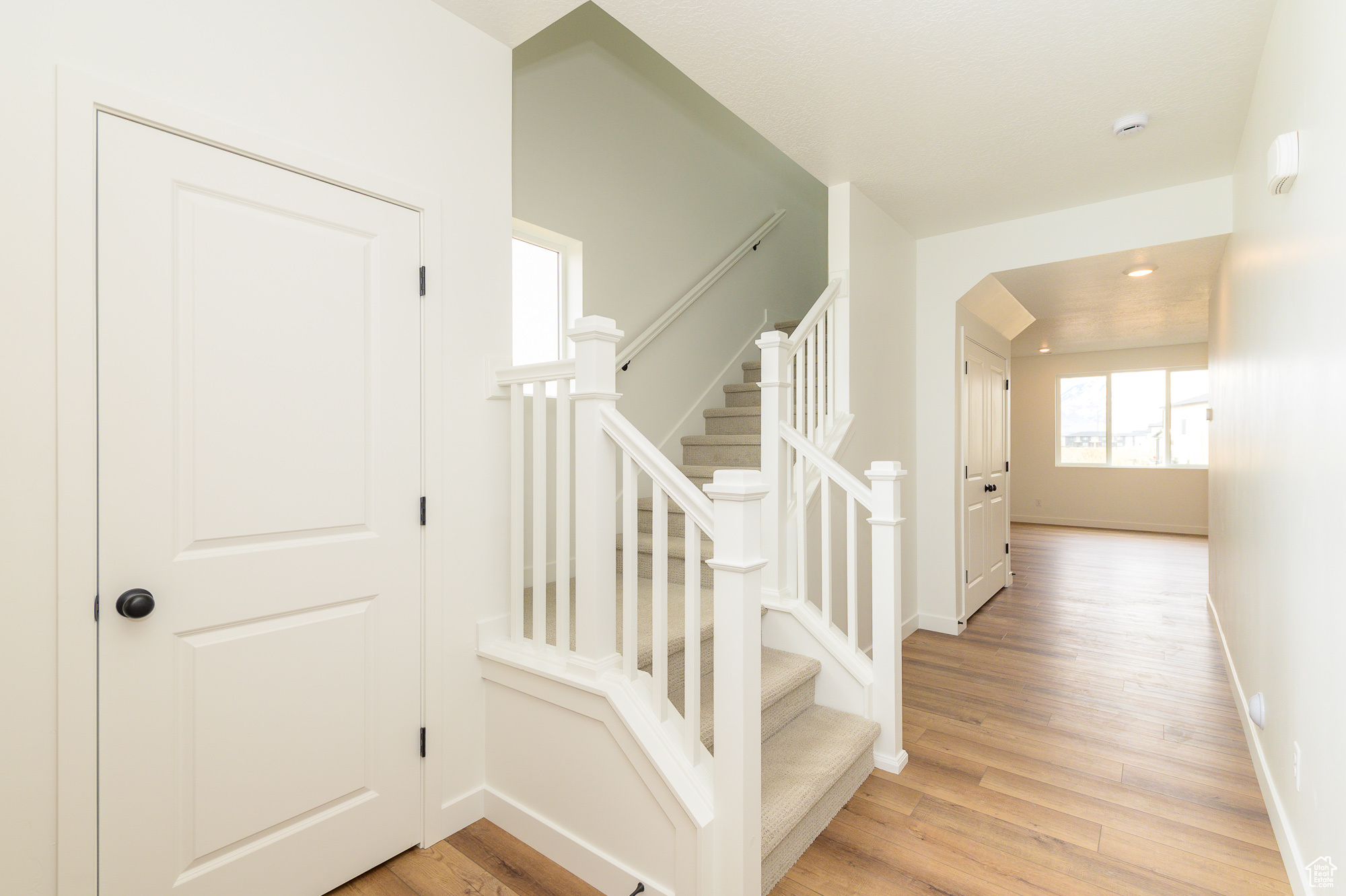 Stairway featuring wood finished floors and baseboards