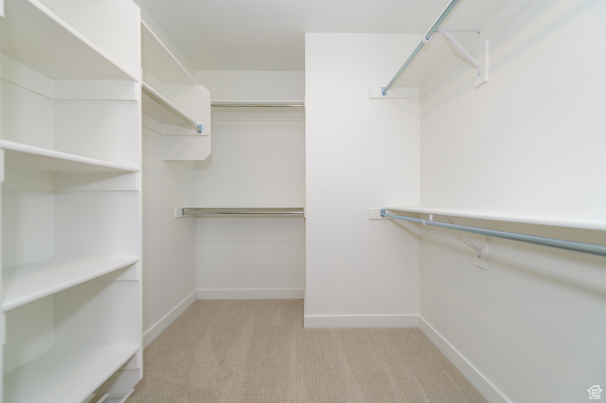 Walk in closet featuring light carpet