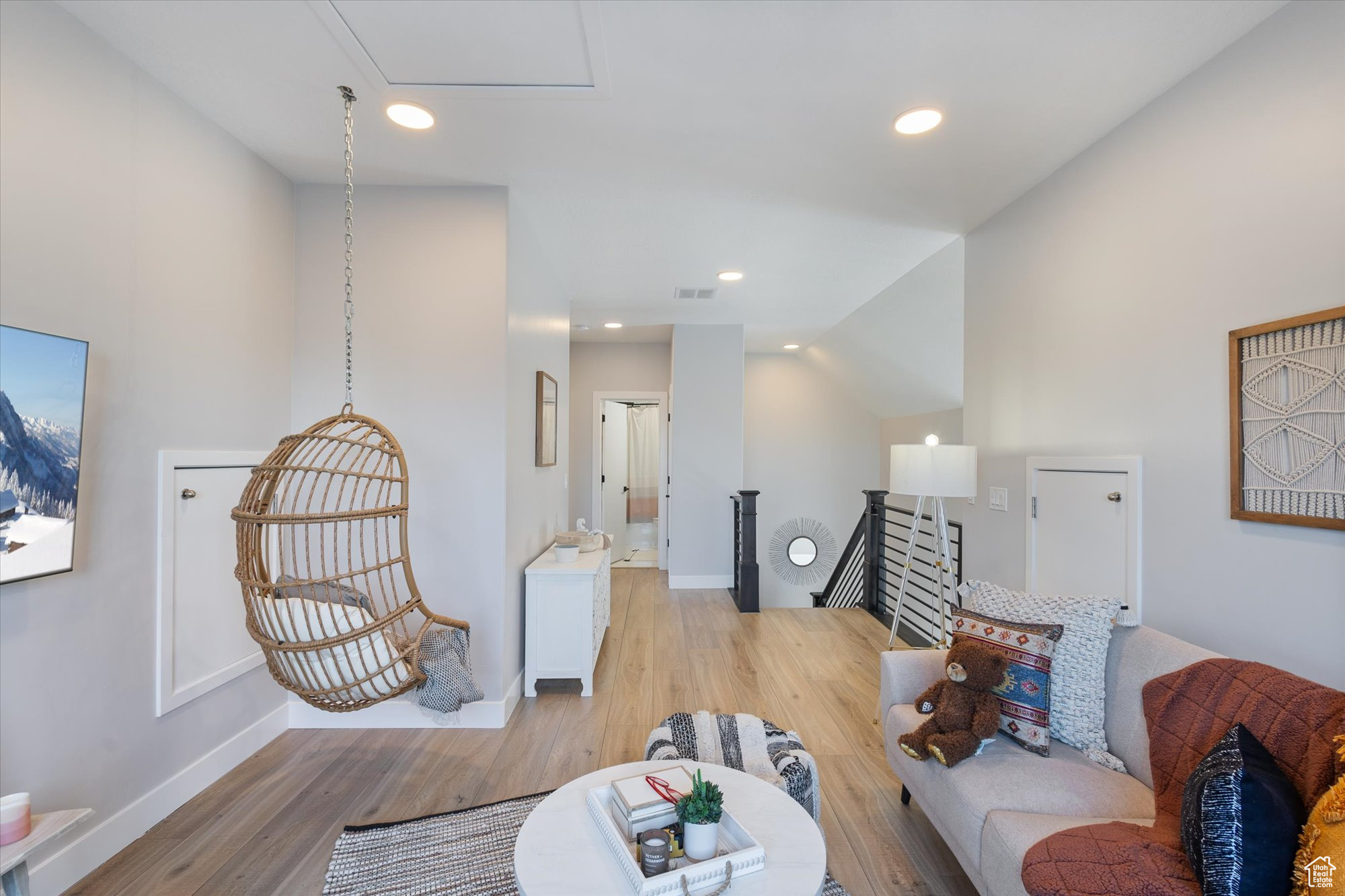 Living room with vaulted ceiling and light hardwood / wood-style floors