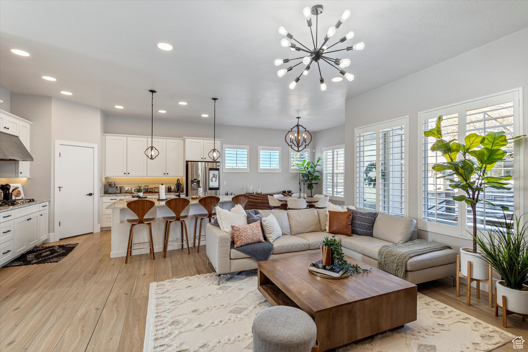 Living room featuring a notable chandelier and light hardwood / wood-style flooring