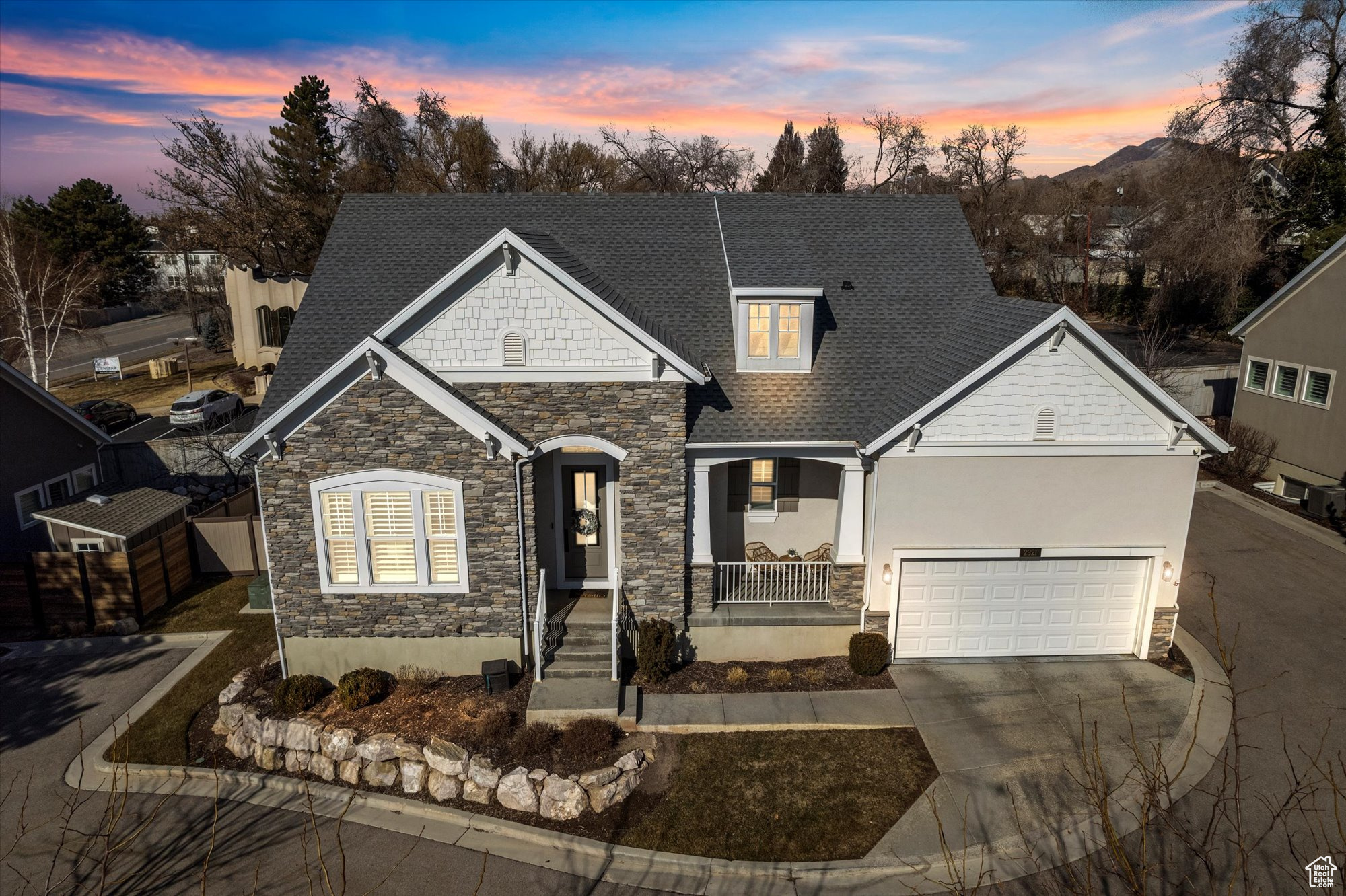 View of front of home with a porch and a garage