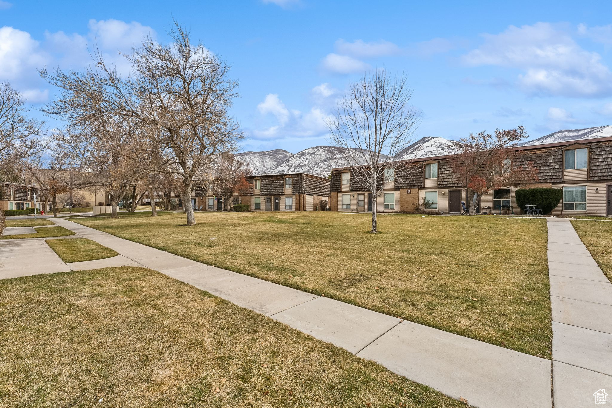 View of home's community with a lawn and a mountain view