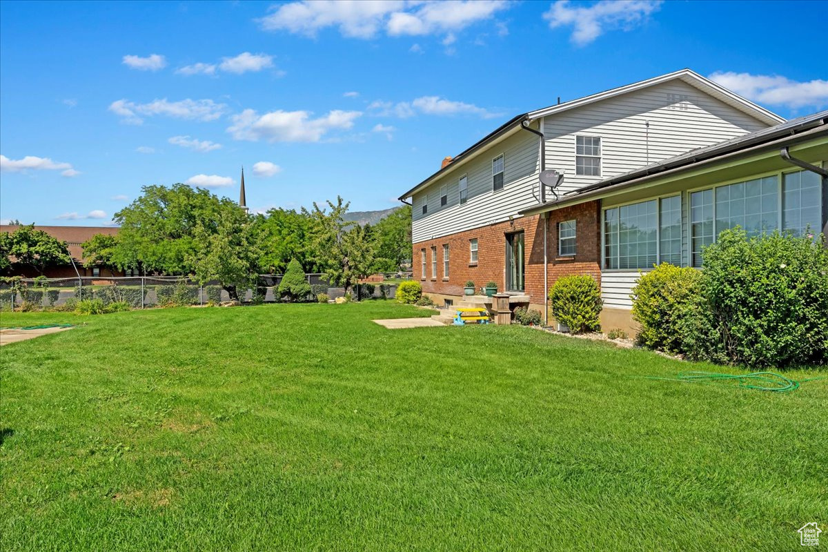 View of yard featuring fence