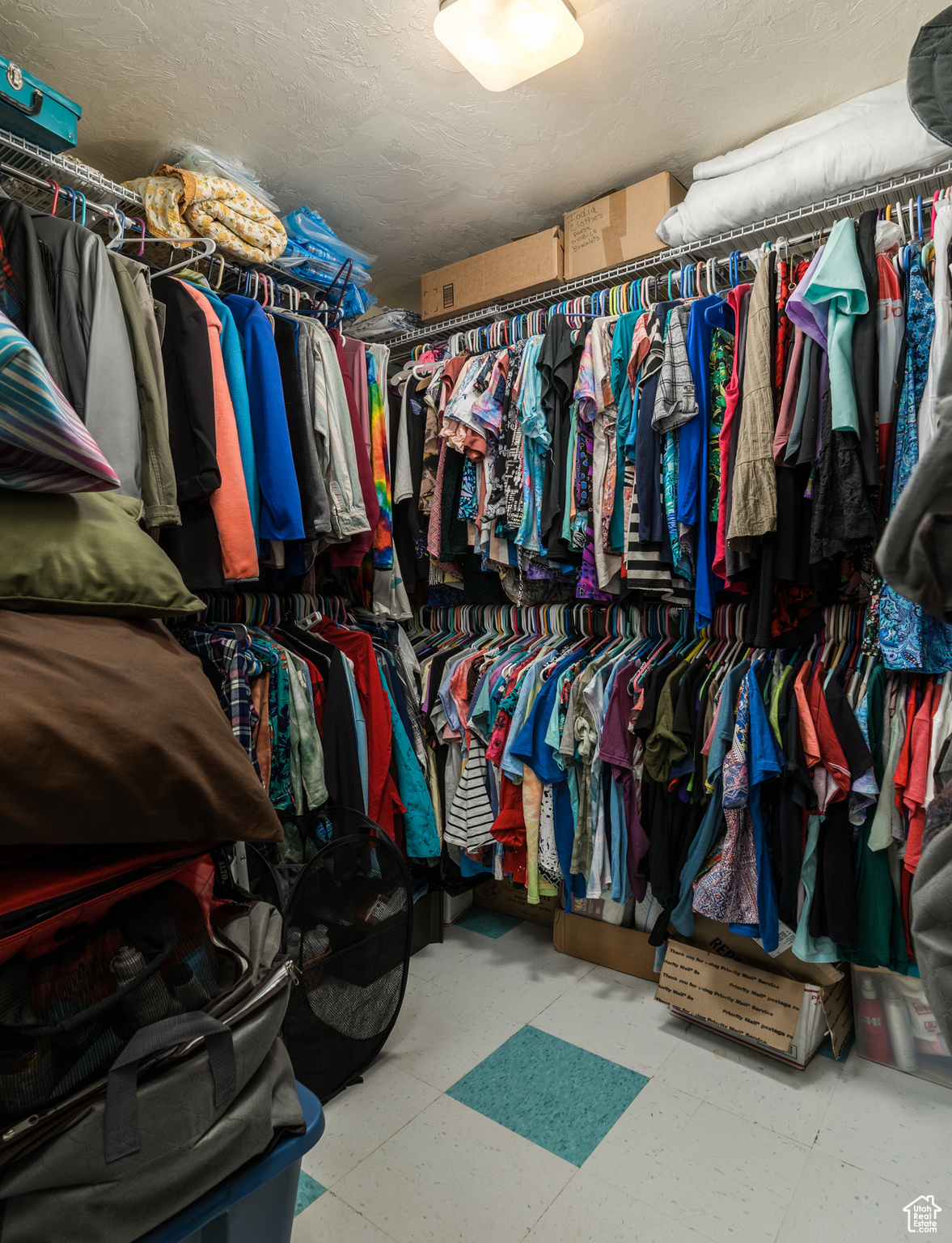 Walk in closet with tile patterned floors