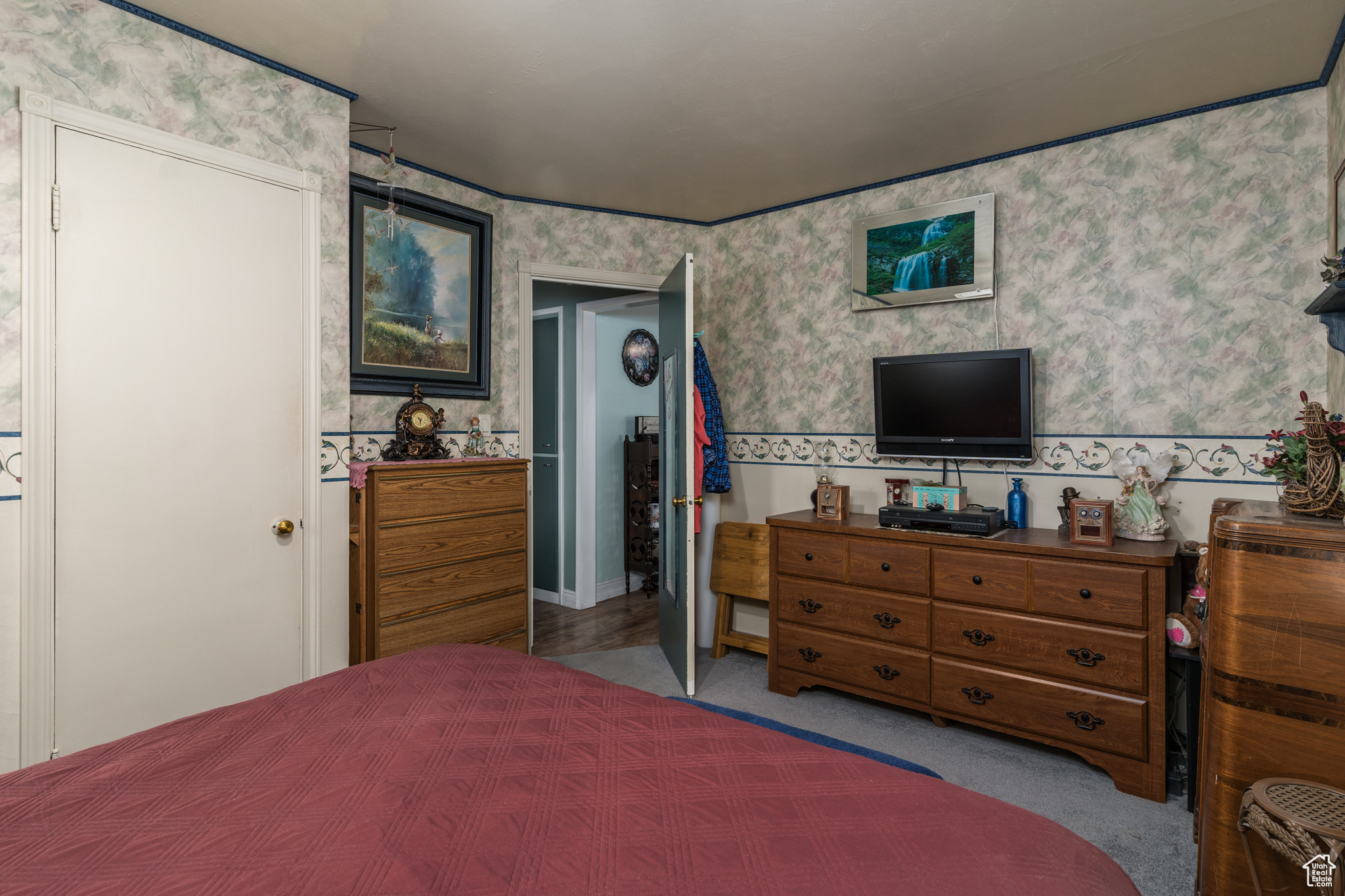 Bedroom featuring wallpapered walls