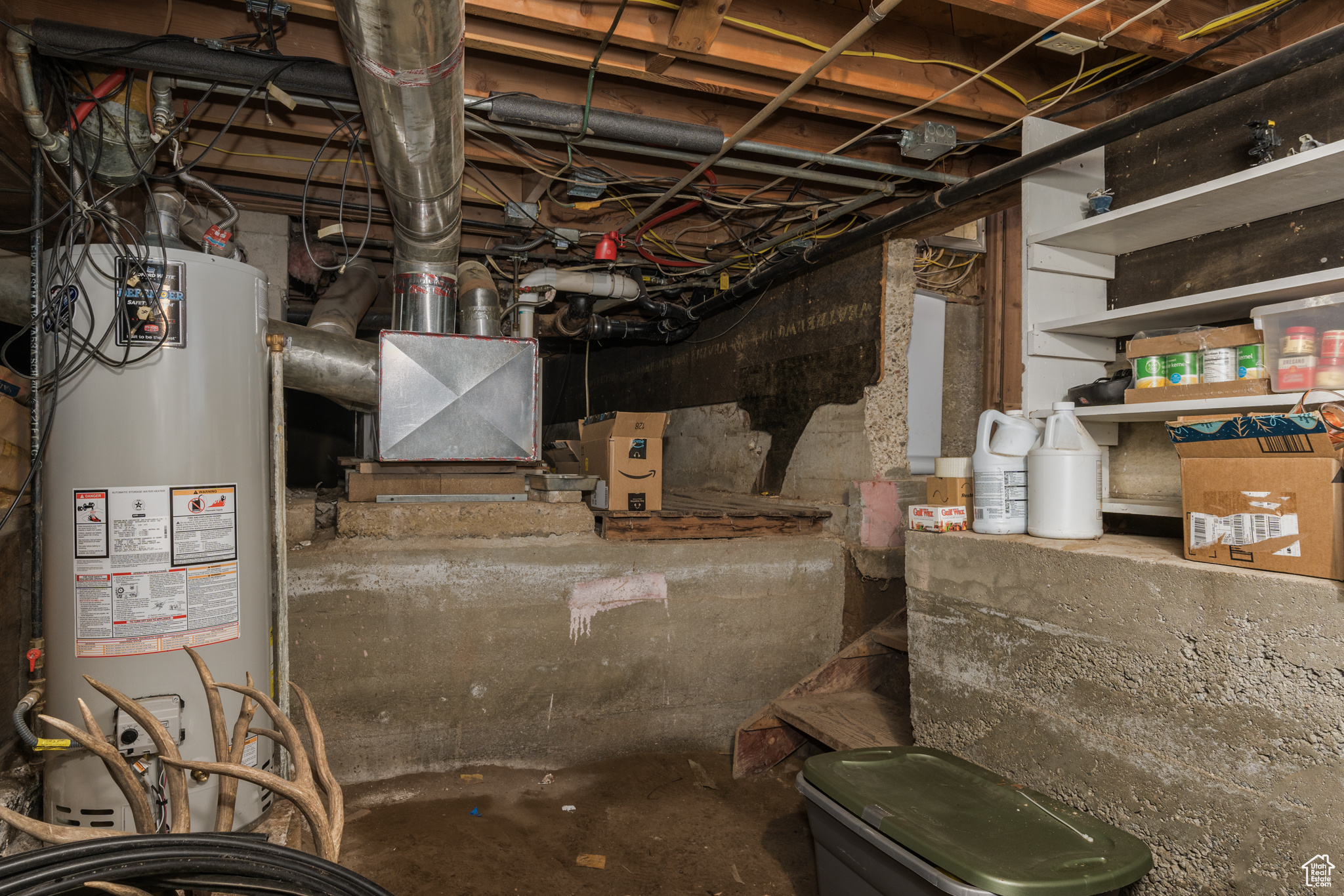 Unfinished basement featuring water heater