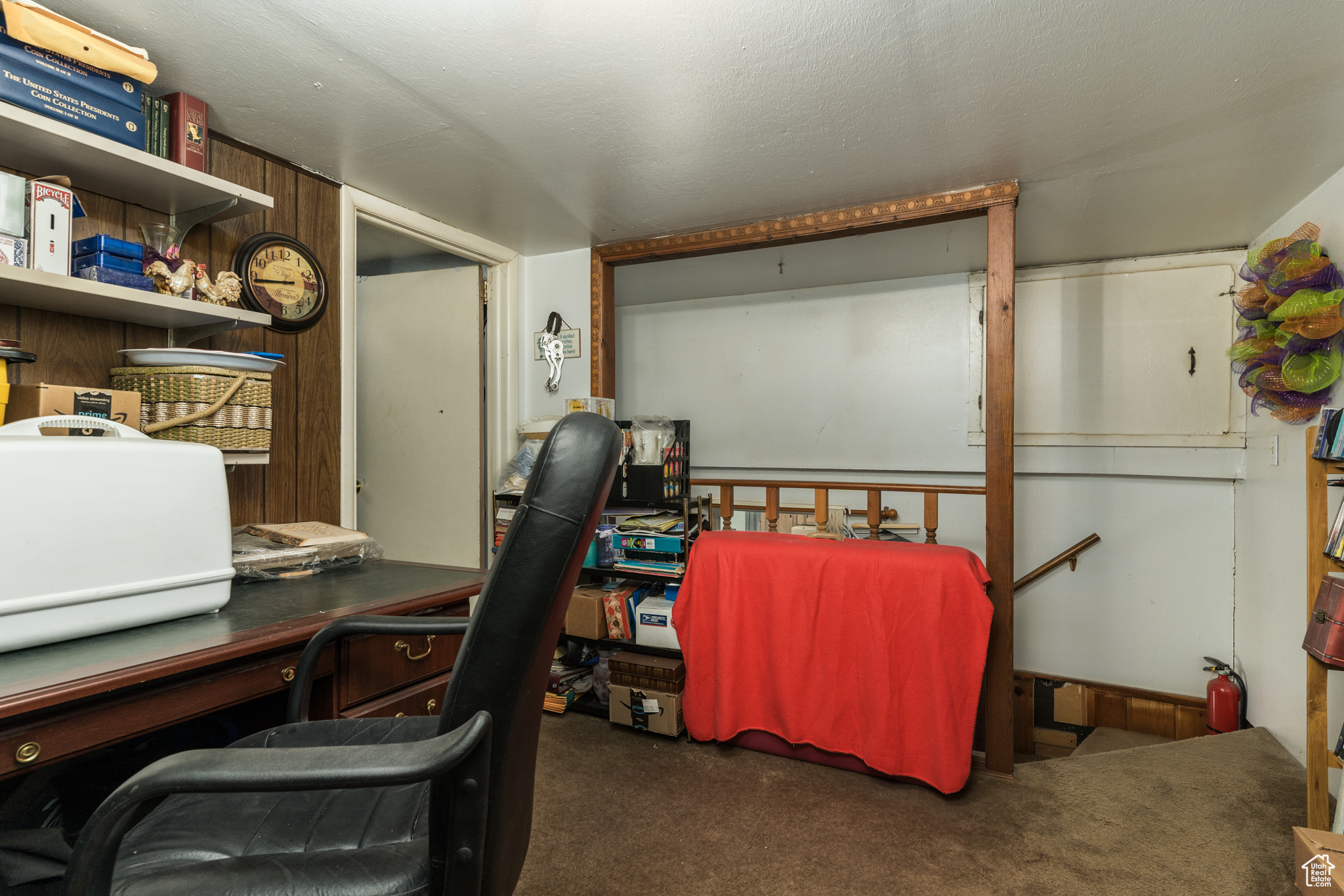 Office featuring a textured ceiling and dark carpet