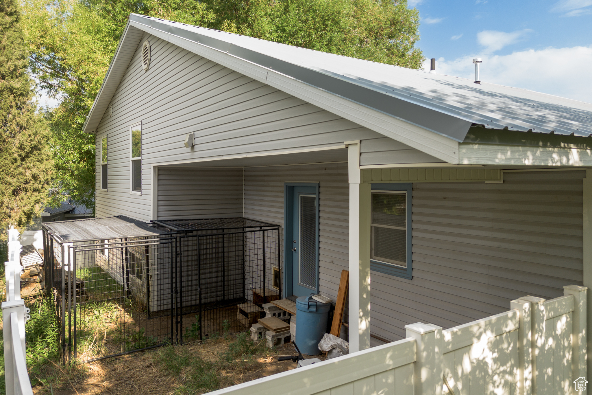 Rear view of property featuring fence