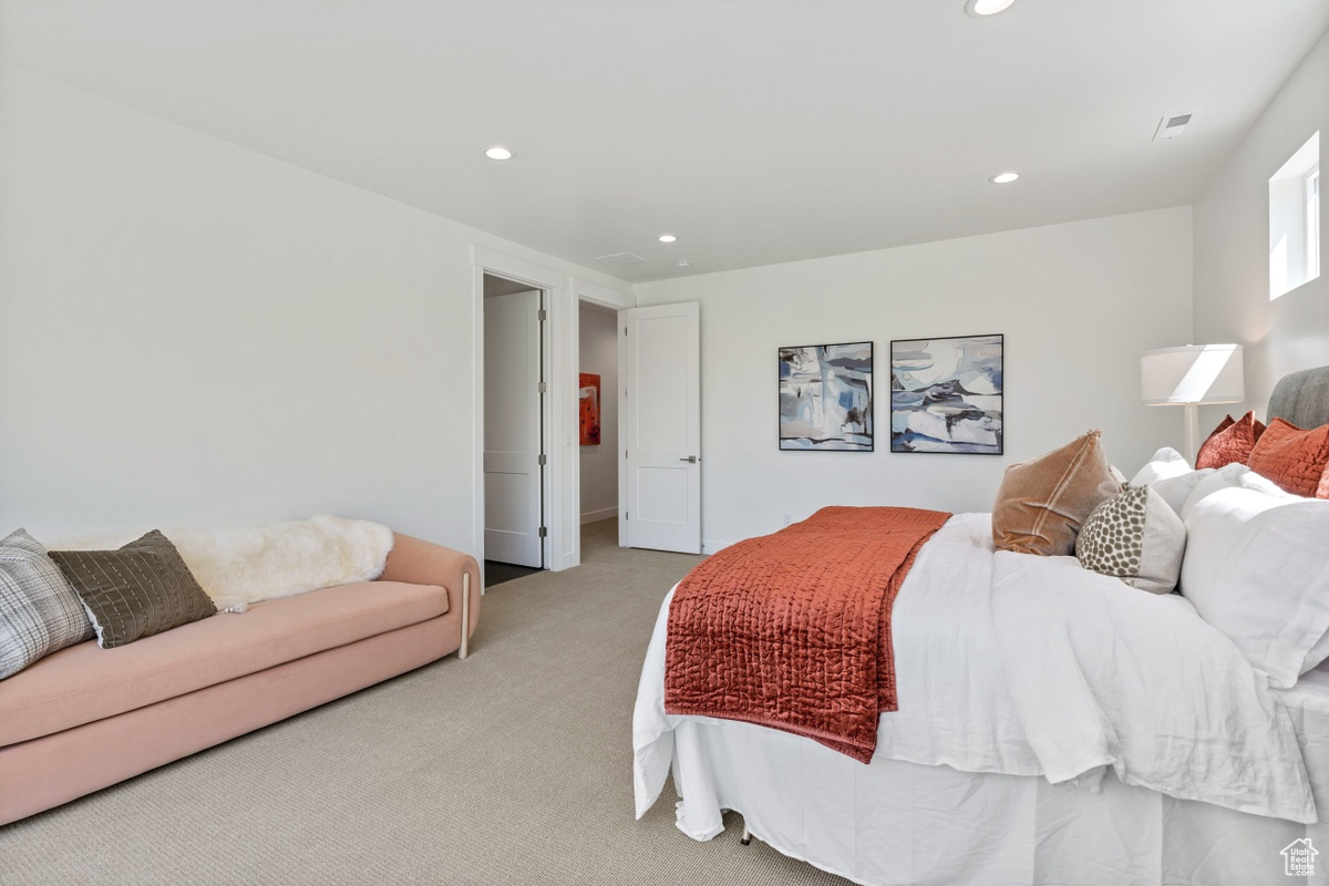 Bedroom featuring recessed lighting, visible vents, and light colored carpet