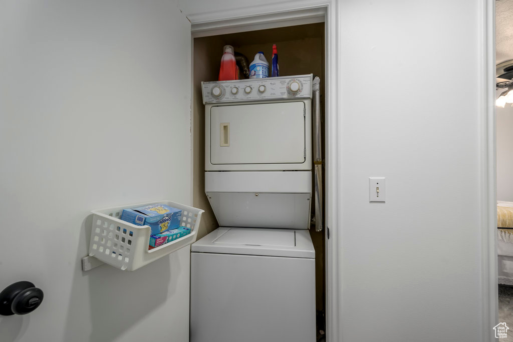 Clothes washing area with laundry area and stacked washing maching and dryer