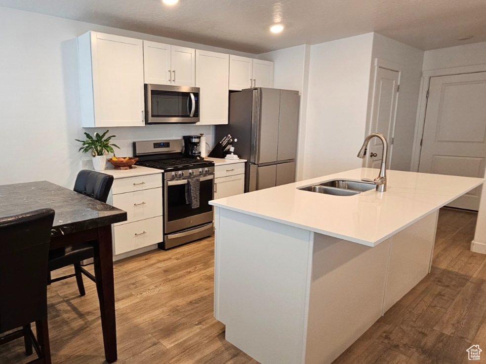 Kitchen featuring a center island with stainless sink and room for 3 stools