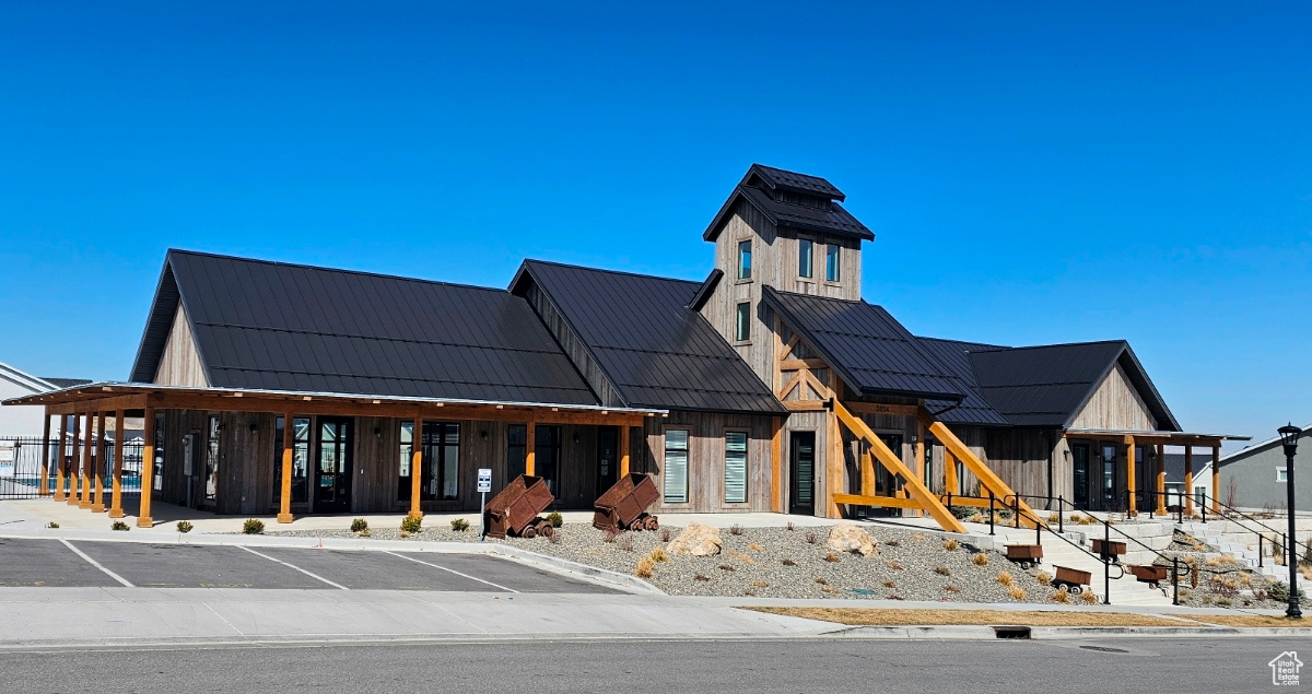 View of property featuring uncovered parking