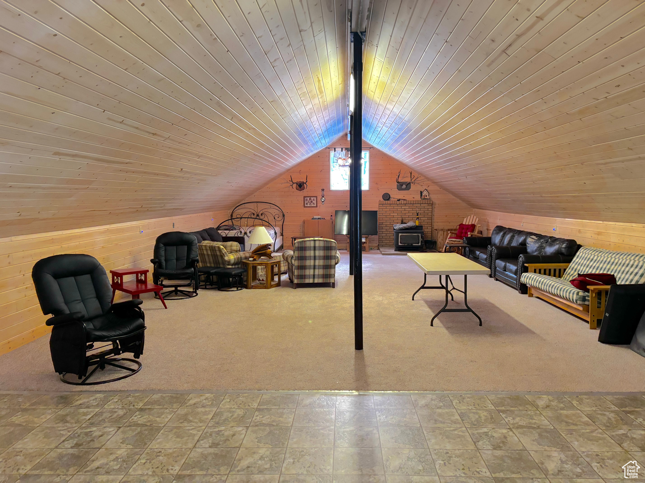 Interior space featuring vaulted ceiling with beams, wood ceiling, and wooden walls