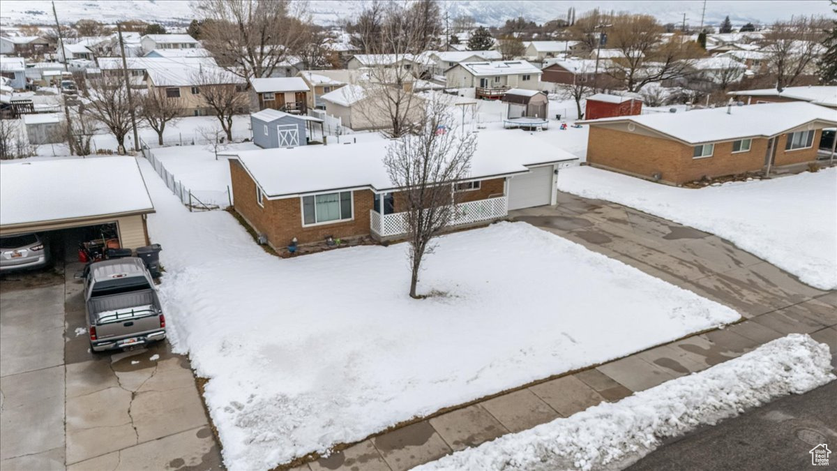 Snowy aerial view with a residential view