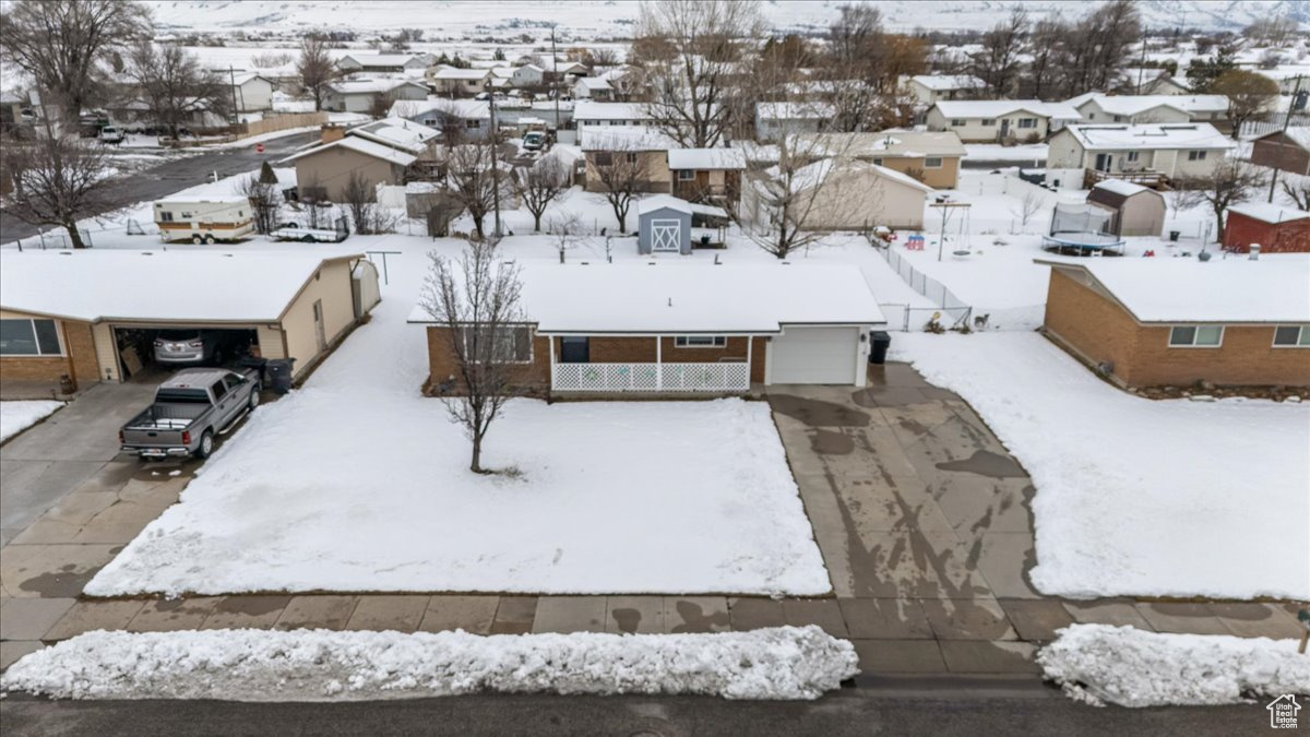 Snowy aerial view with a residential view