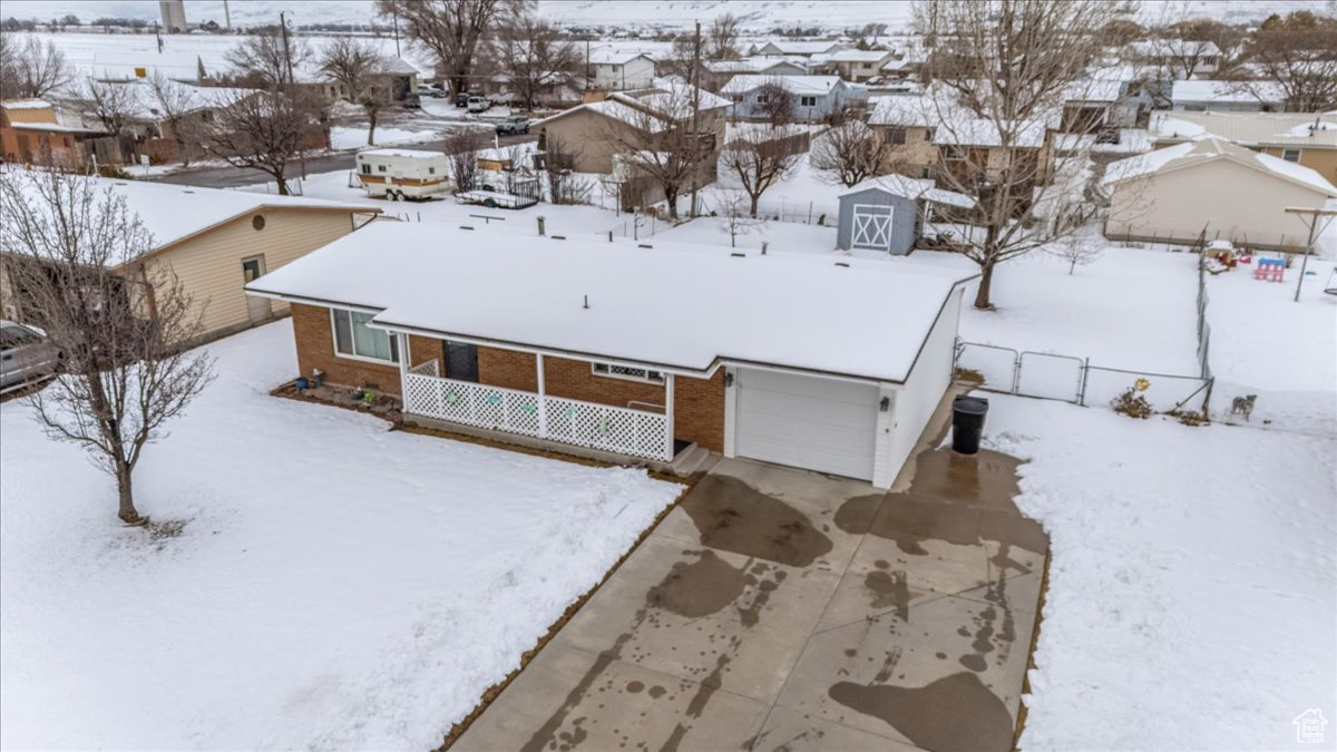 Snowy aerial view featuring a residential view