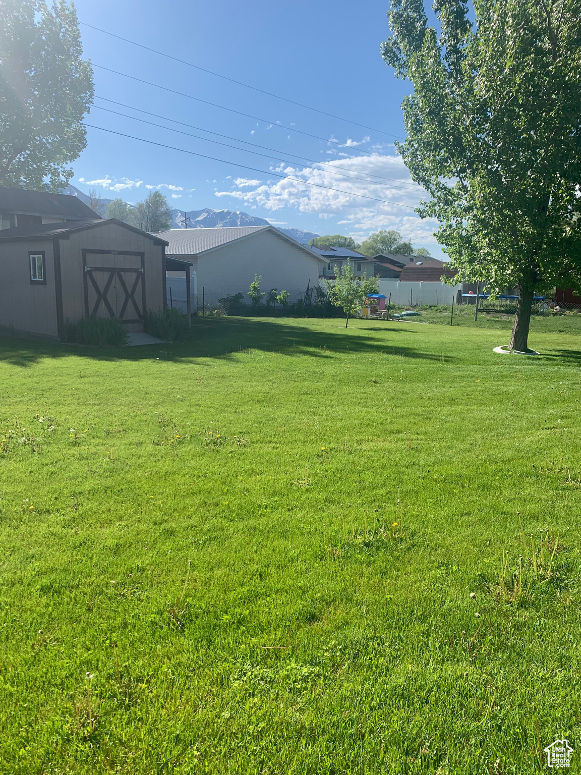 View of yard with a storage shed and an outdoor structure