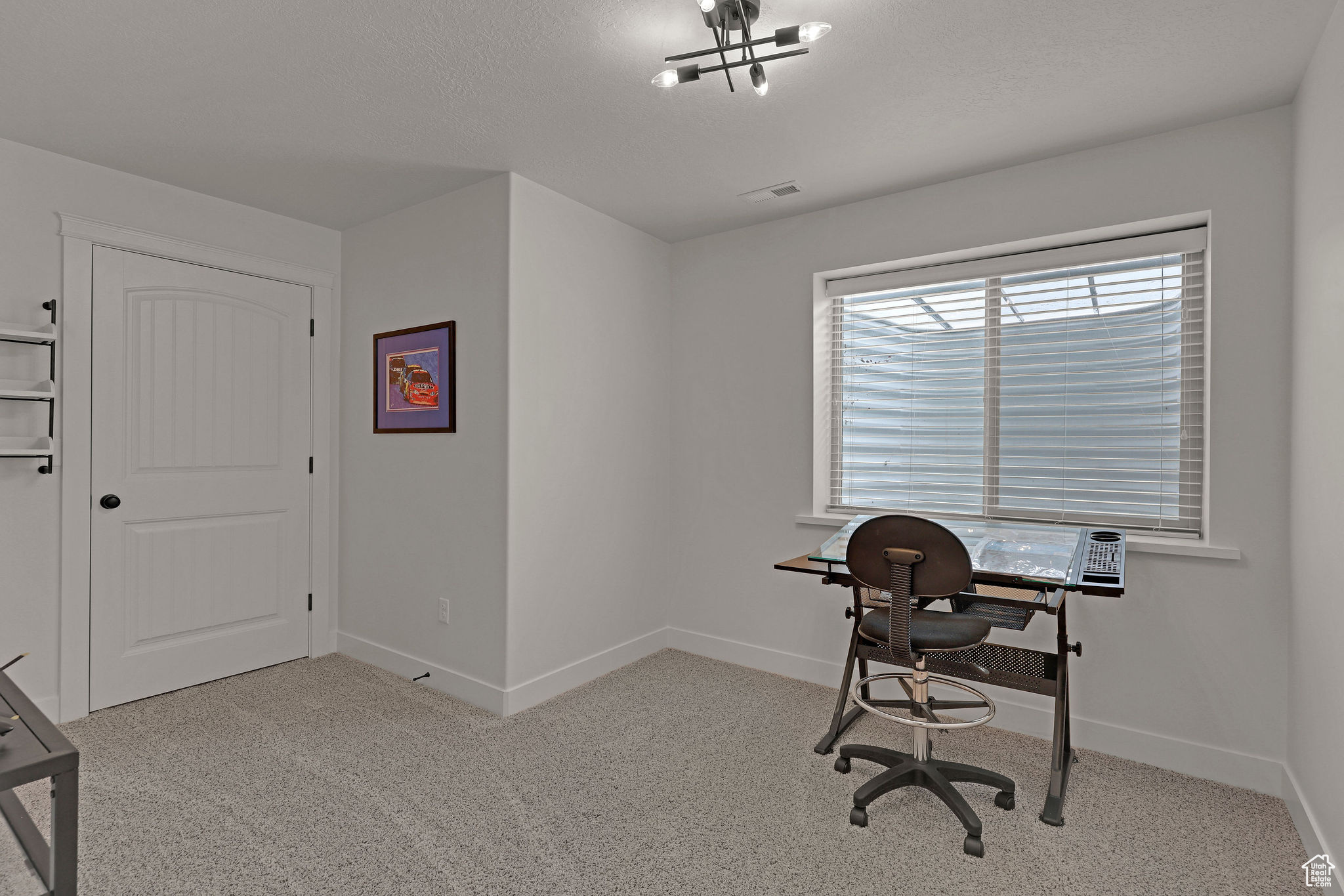 Office space featuring light colored carpet