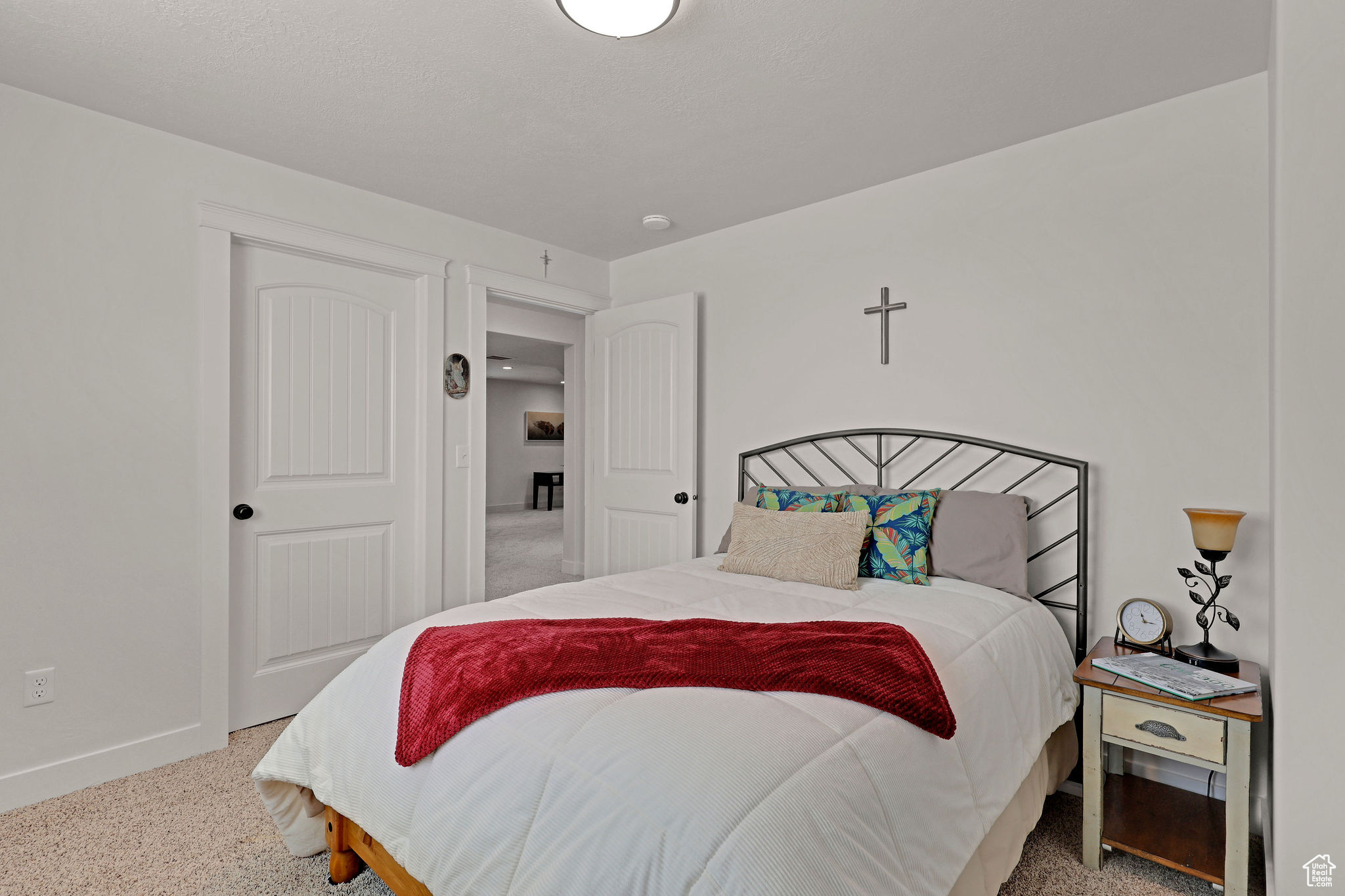 Bedroom featuring light carpet
