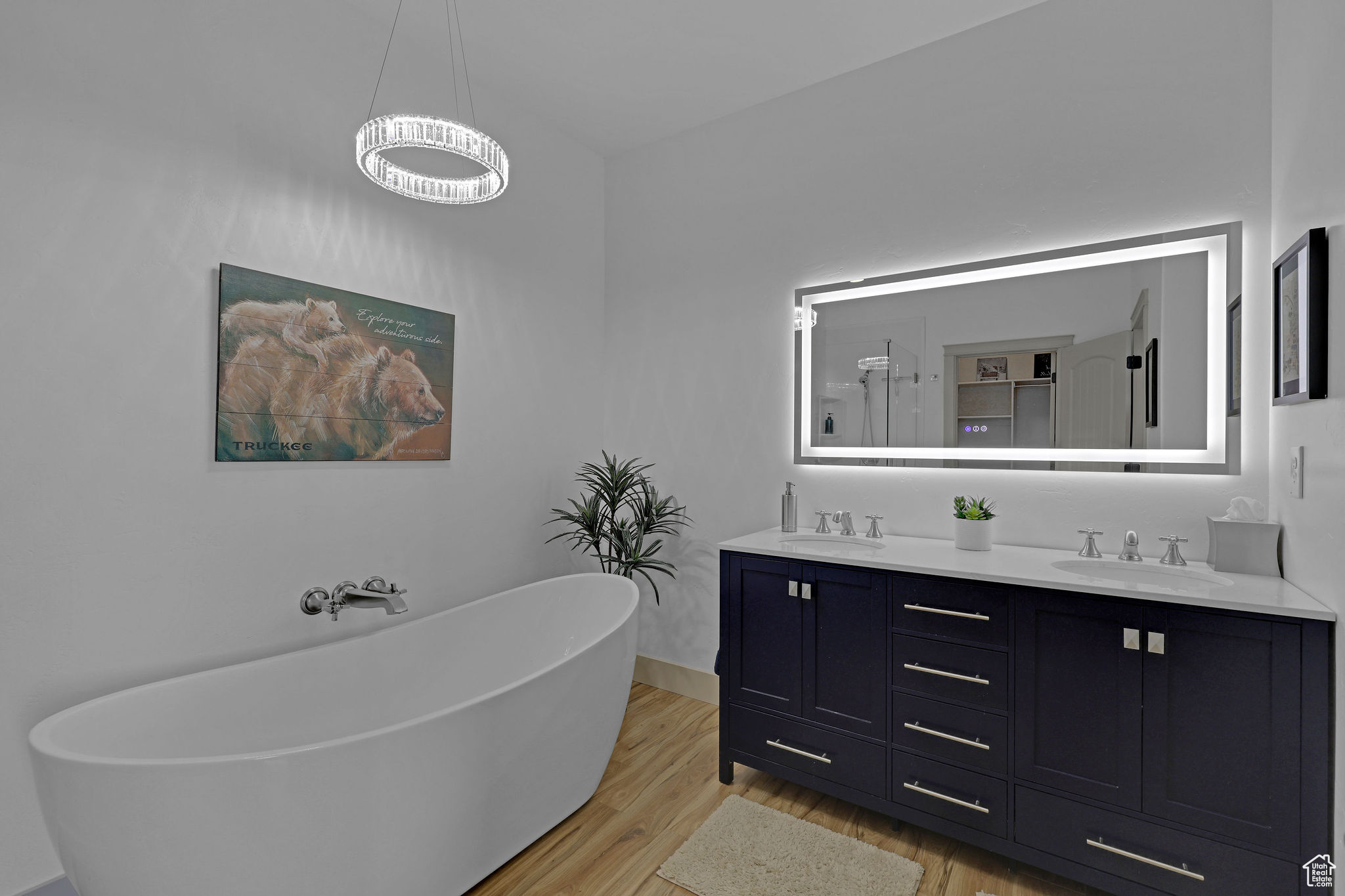 Bathroom featuring hardwood / wood-style flooring, vanity, and a bathing tub