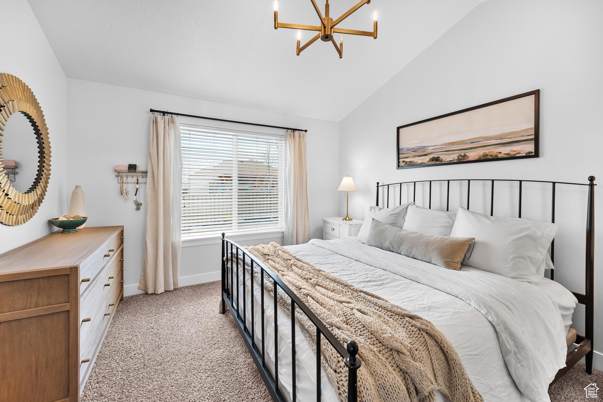 Bedroom featuring a chandelier, lofted ceiling.