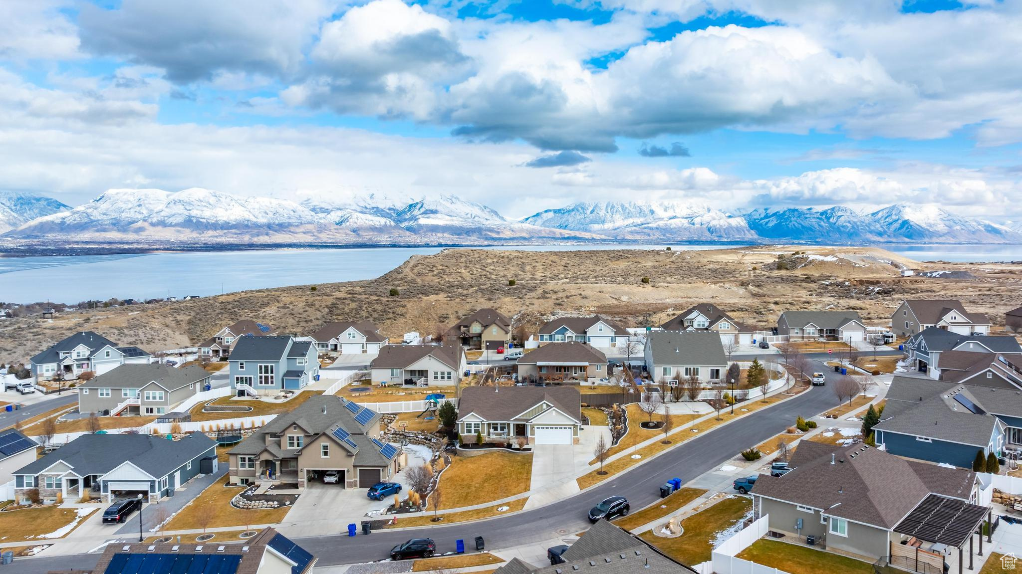 Birds eye view of property with a residential view and a water and mountain view