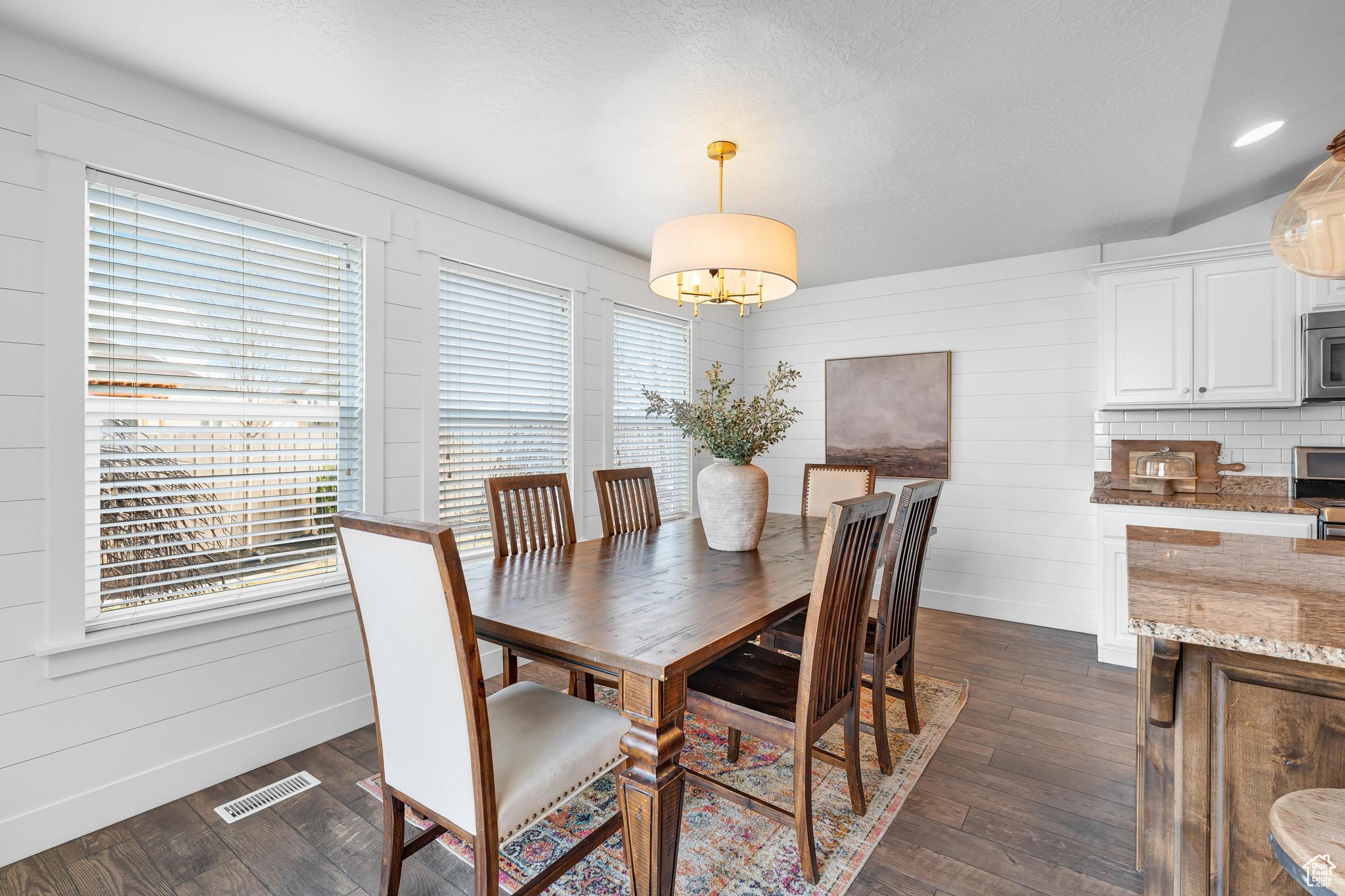 Dining room featuring lighting and windows.
