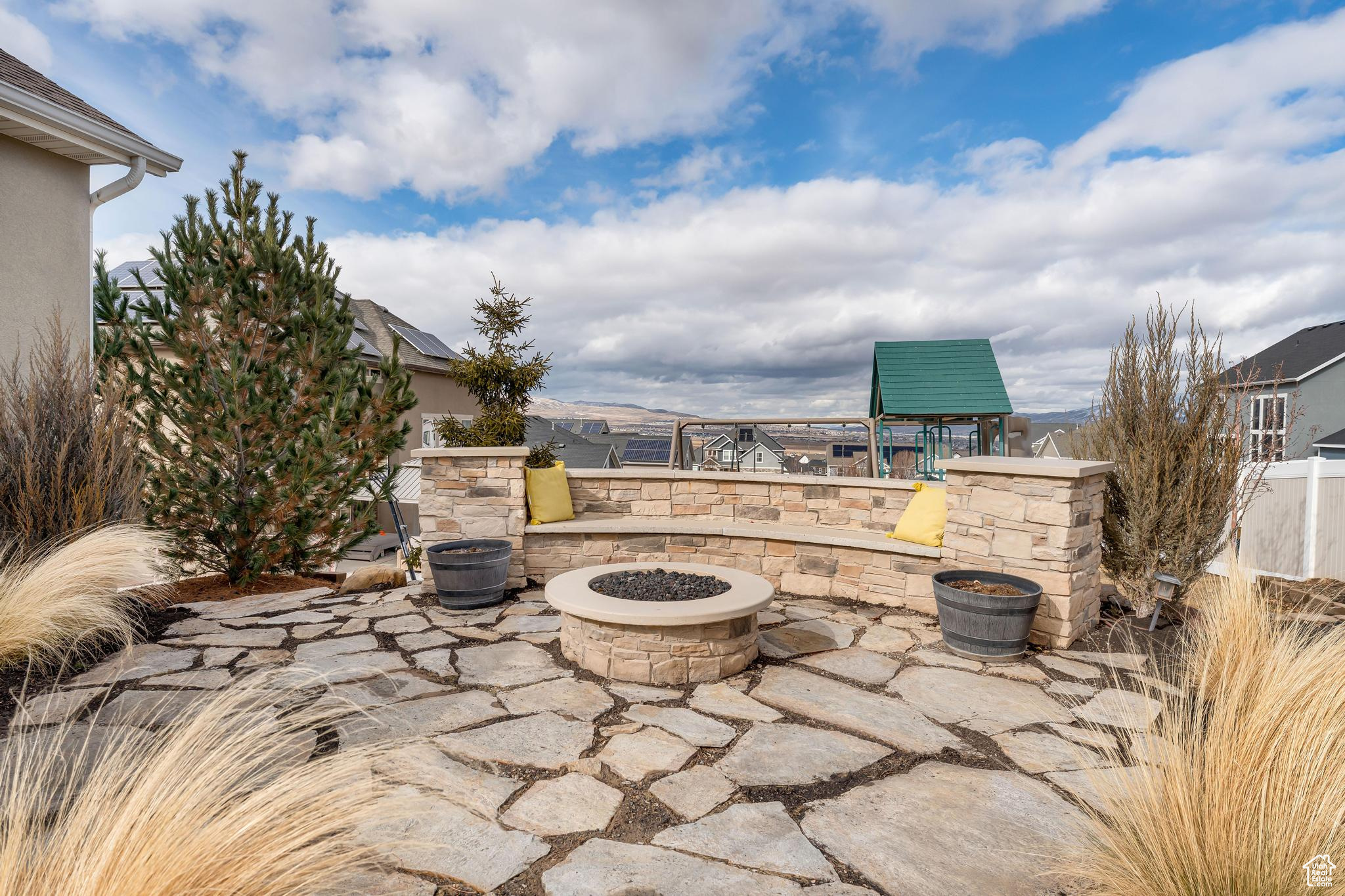 View of patio with a fire pit