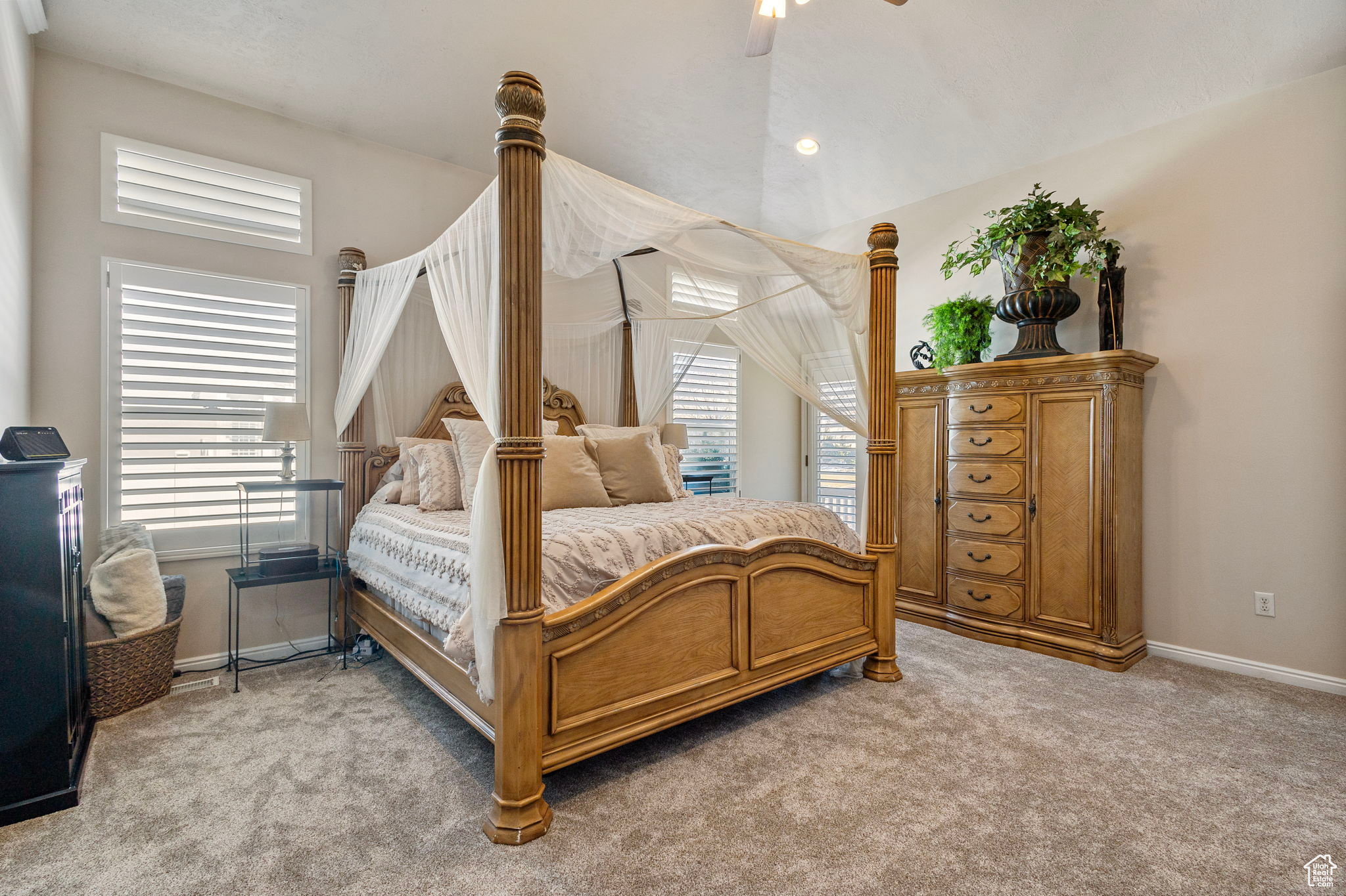 Carpeted bedroom with ceiling fan