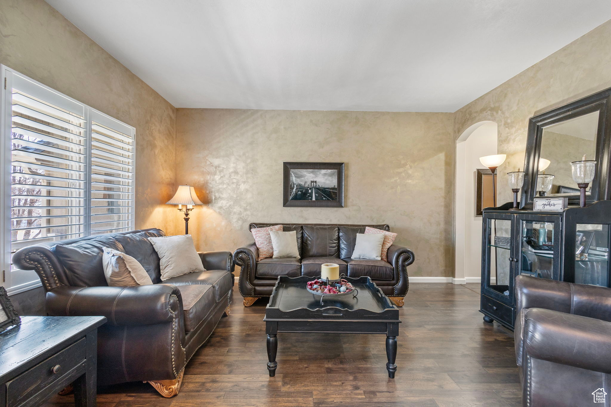 Living room with dark wood-type flooring