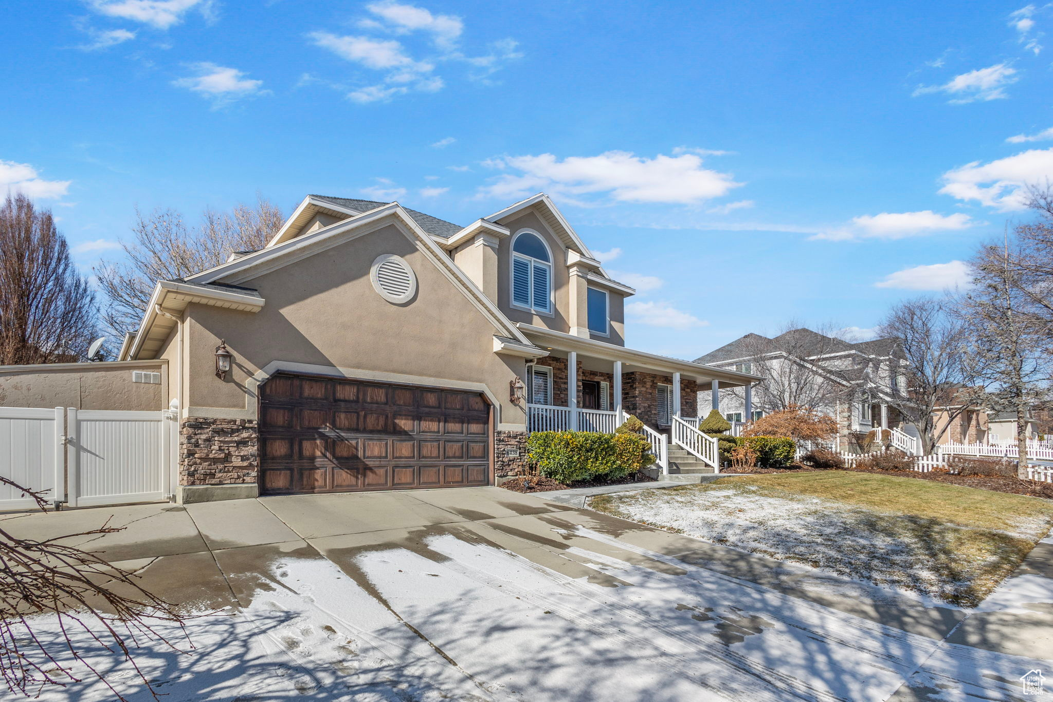 View of front property with a porch and a garage