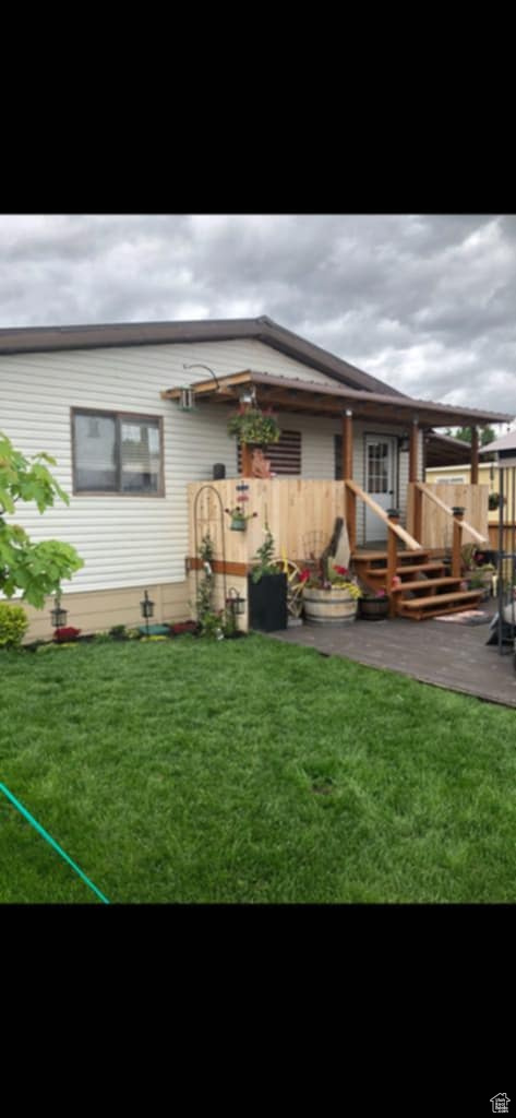 Rear view of house featuring a yard