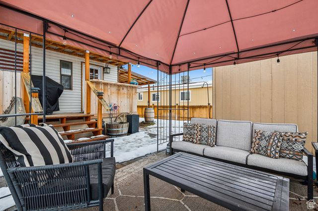 View of patio featuring a gazebo and an outdoor living space
