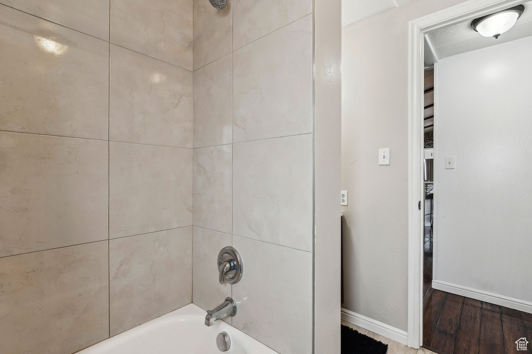 Full bathroom featuring shower / washtub combination and baseboards