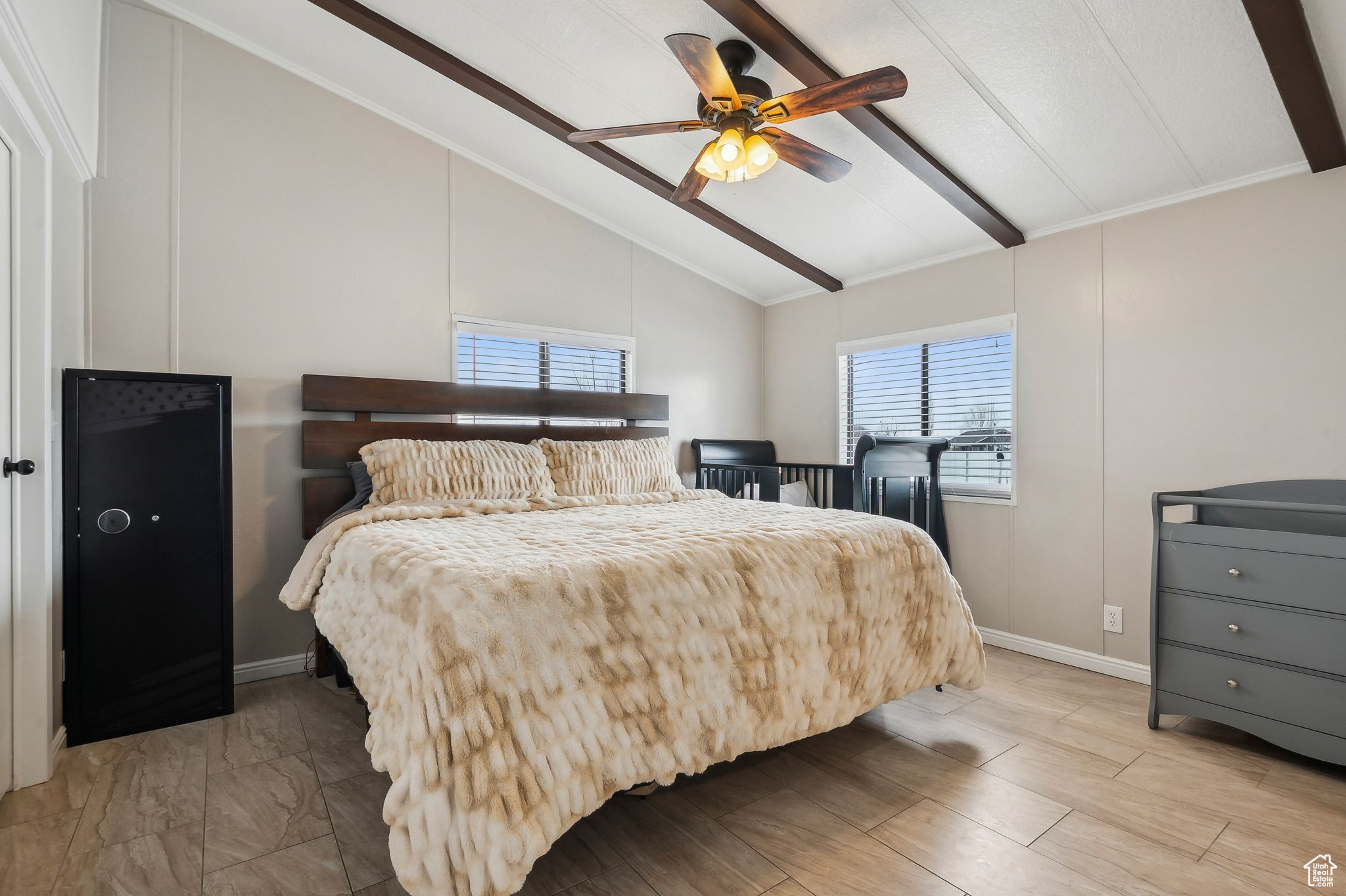 Bedroom with lofted ceiling with beams, light wood-style flooring, baseboards, and a ceiling fan