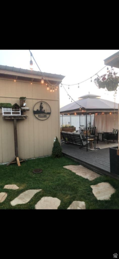View of yard with area for grilling, a deck, and a gazebo