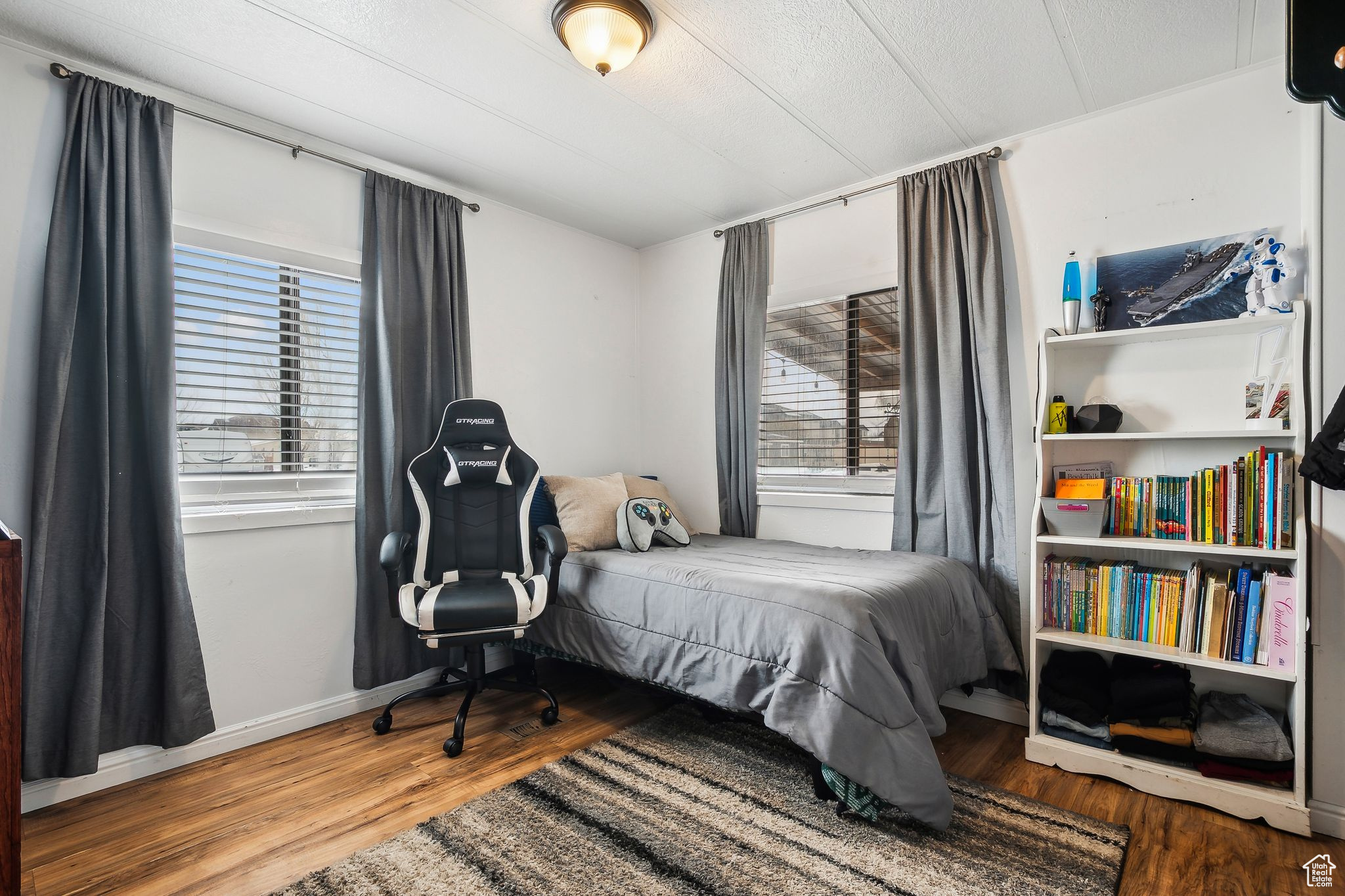 Bedroom with baseboards and wood finished floors