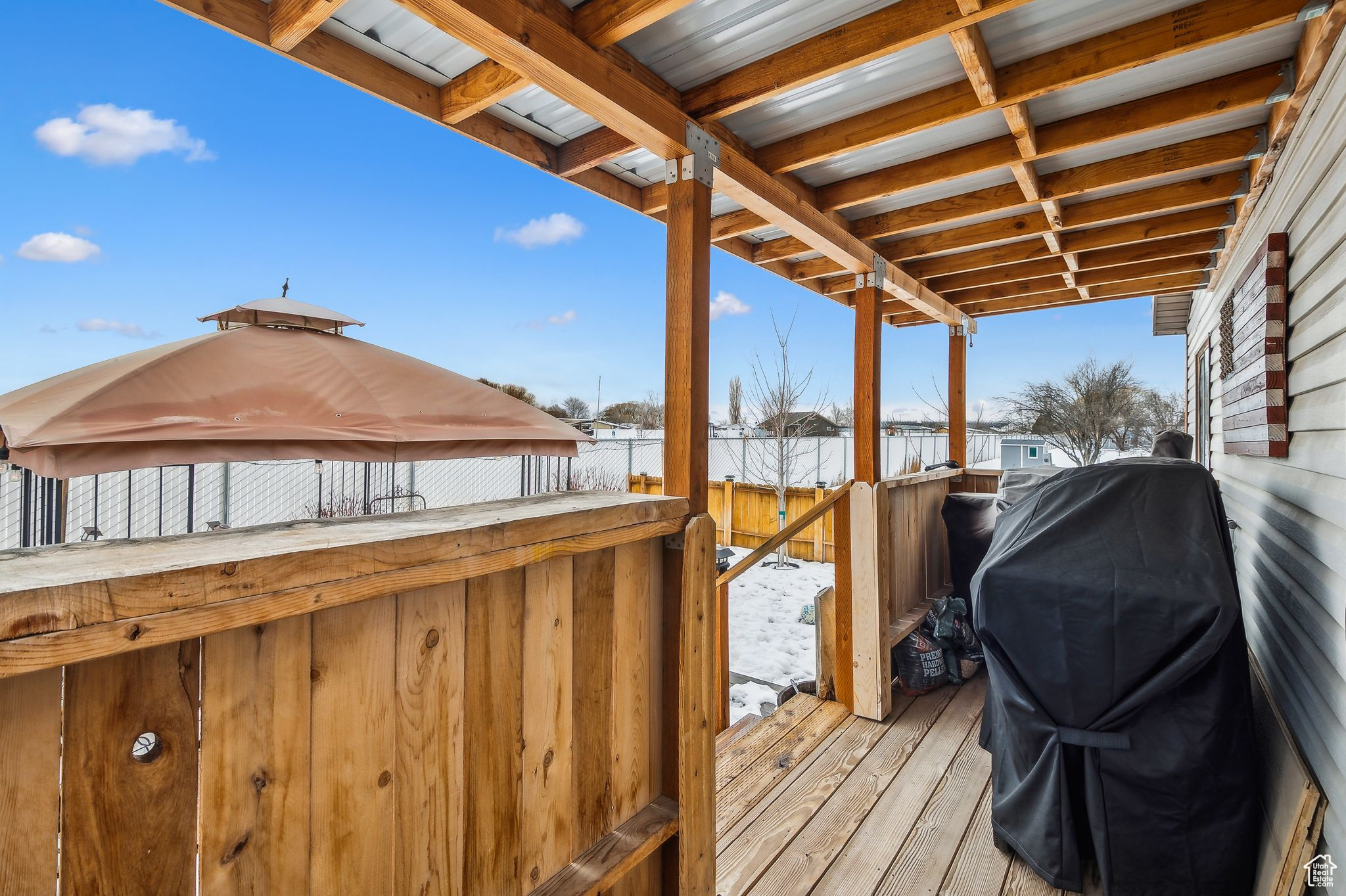 Wooden deck featuring area for grilling