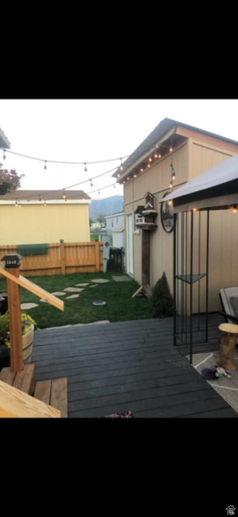 Wooden terrace featuring a lawn
