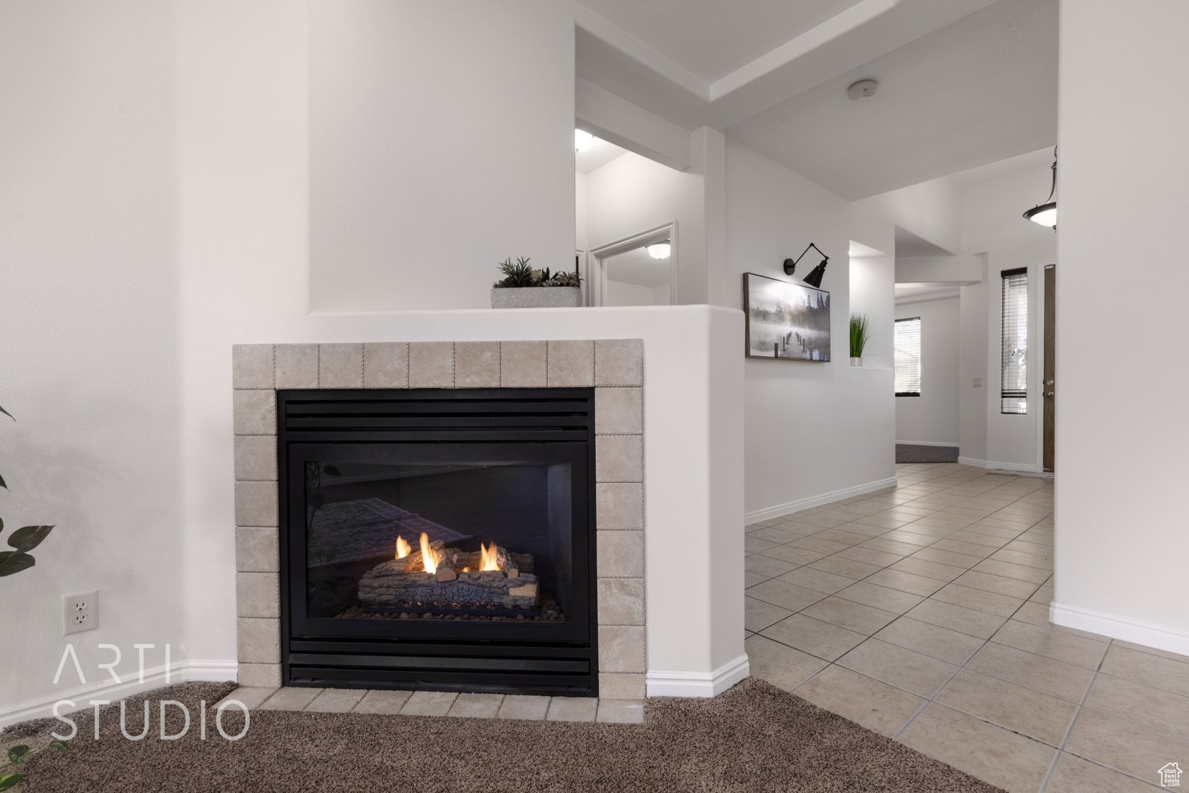 Room details with a tiled fireplace and carpet floors